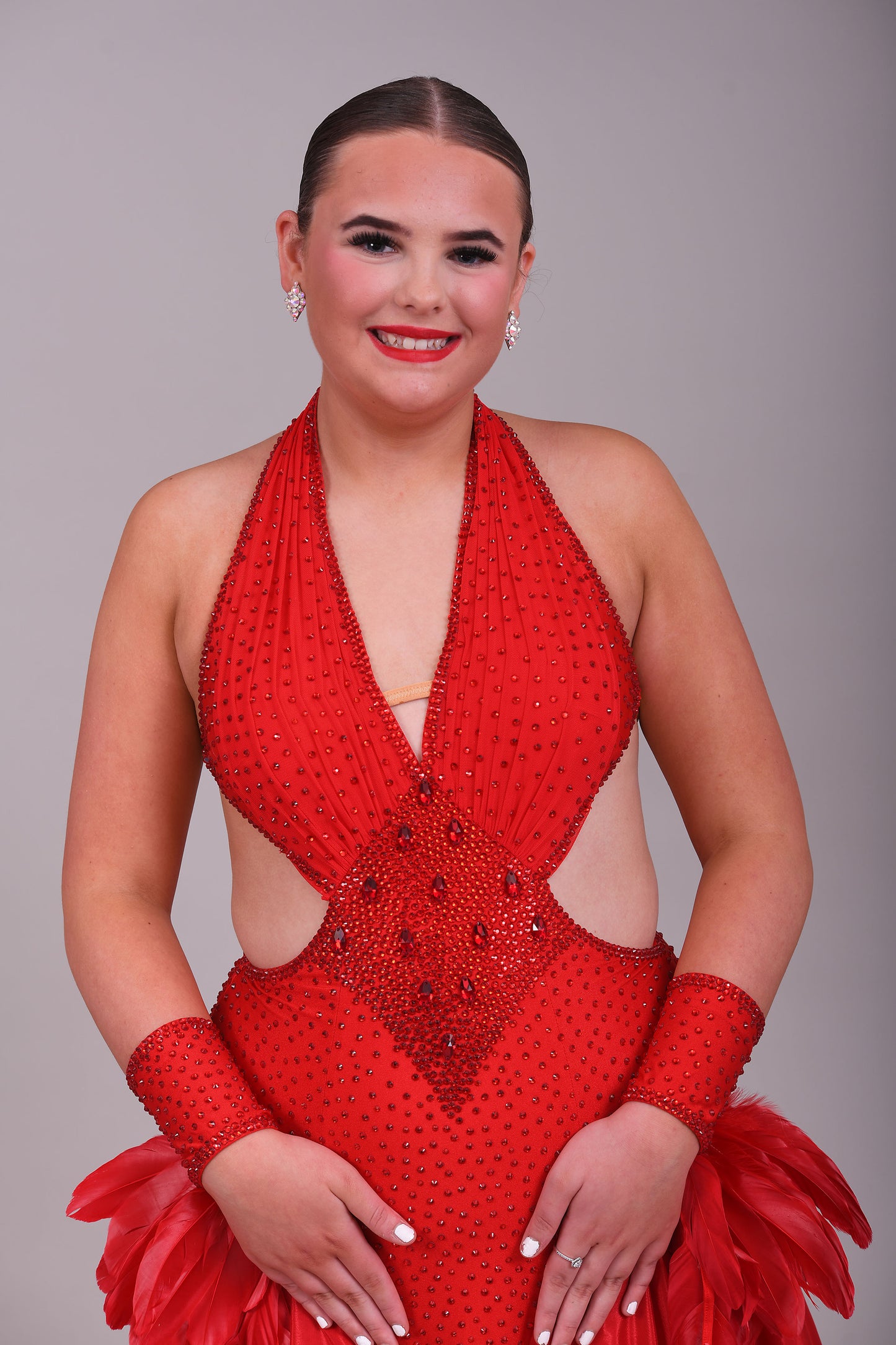 219 Red Sleeveless/Backless Ballroom/Smooth halter neck Dress. Feature panelling to the waist. Long Glove let’s with feather detailing. Flesh strapping to the chest and back.