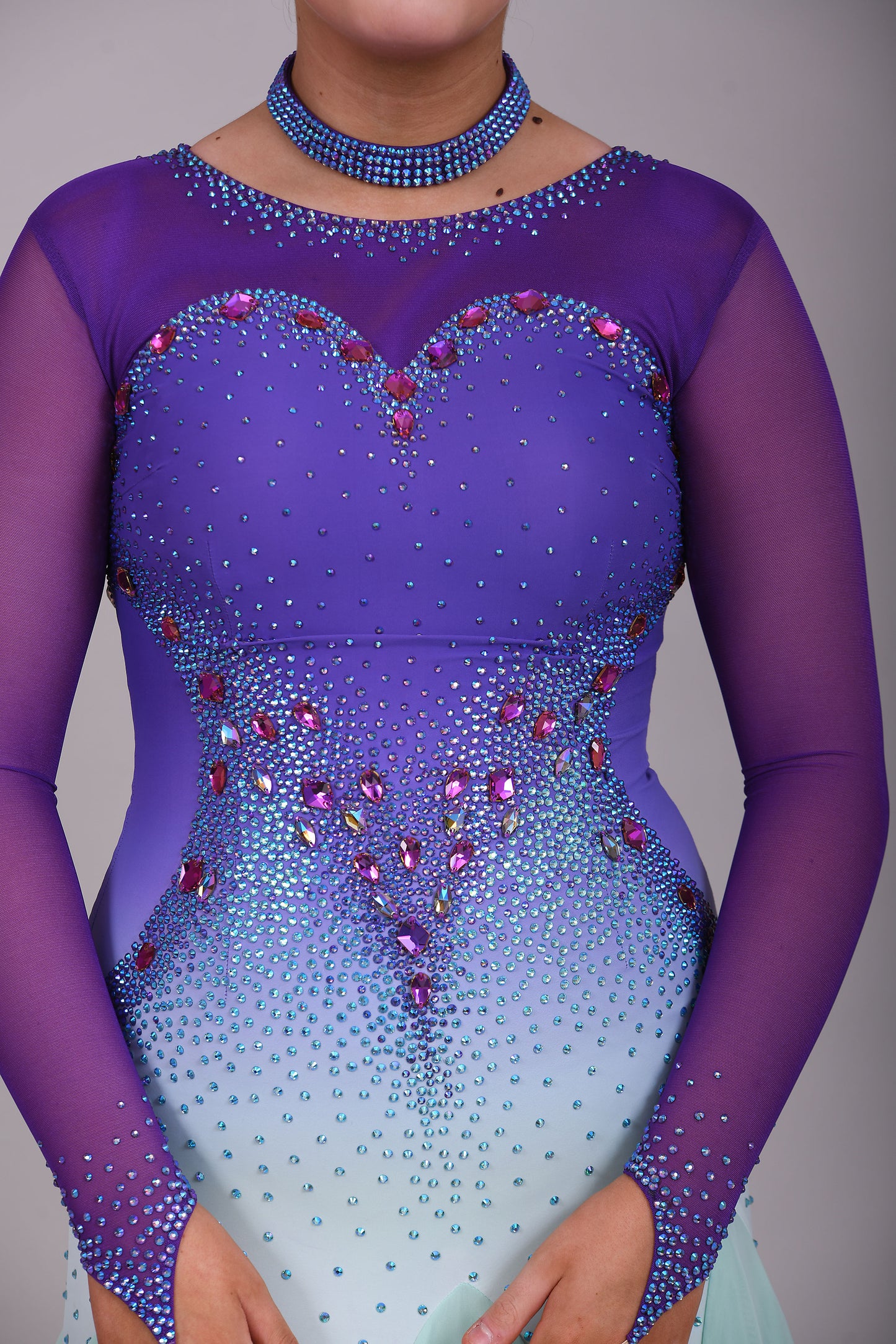 167 Ombré purple to mint green competition Ballroom dance dress. Stoned in mint green, mint green ab, purple & vitrail. Ostrich feather floats attached to stoned strips. High back to give the option of wearing own bra.
