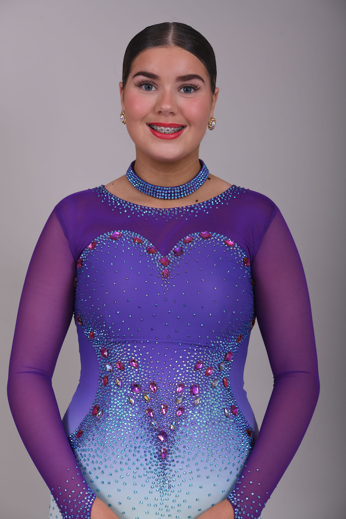 167 Ombré purple to mint green competition Ballroom dance dress. Stoned in mint green, mint green ab, purple & vitrail. Ostrich feather floats attached to stoned strips. High back to give the option of wearing own bra.