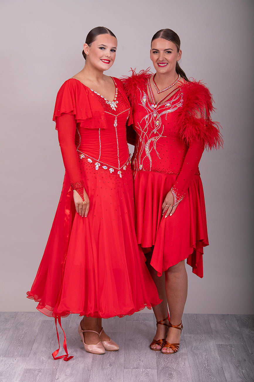 301 Rich Red Competition Latin Dance Dress. Ostrich boa decoration to the upper arm with stoned strap detail. Very full skirt. Stoned in Light Siam & AB