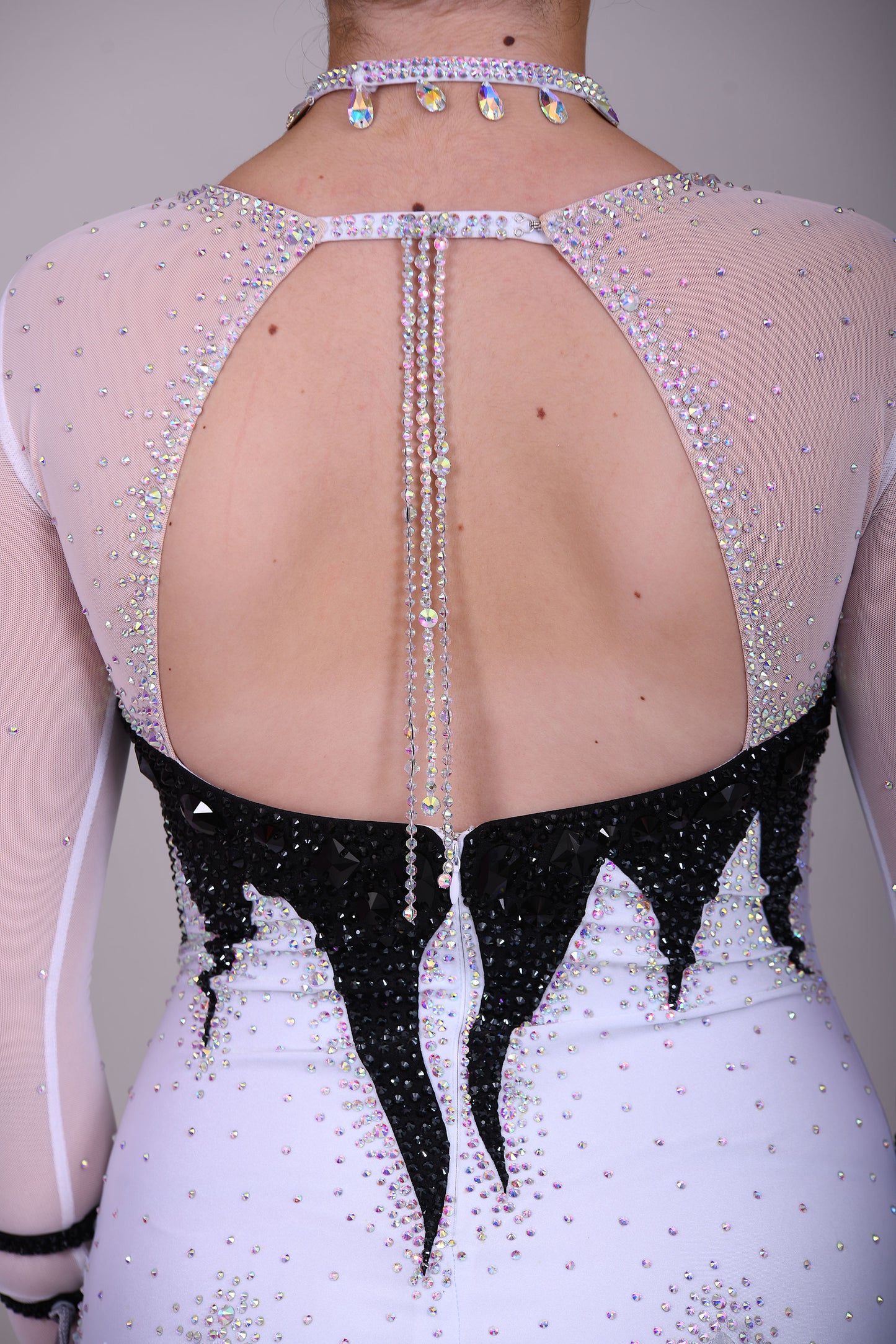 01140 Black & White Ombre Competition Ballroom Dance Dress Upper chest heavily stoned Jet. Pearl Chiffon Ombre skirts. The upper chest is white mesh with skin fabric underneath, giving the illusion of skin. Detachable Floats.