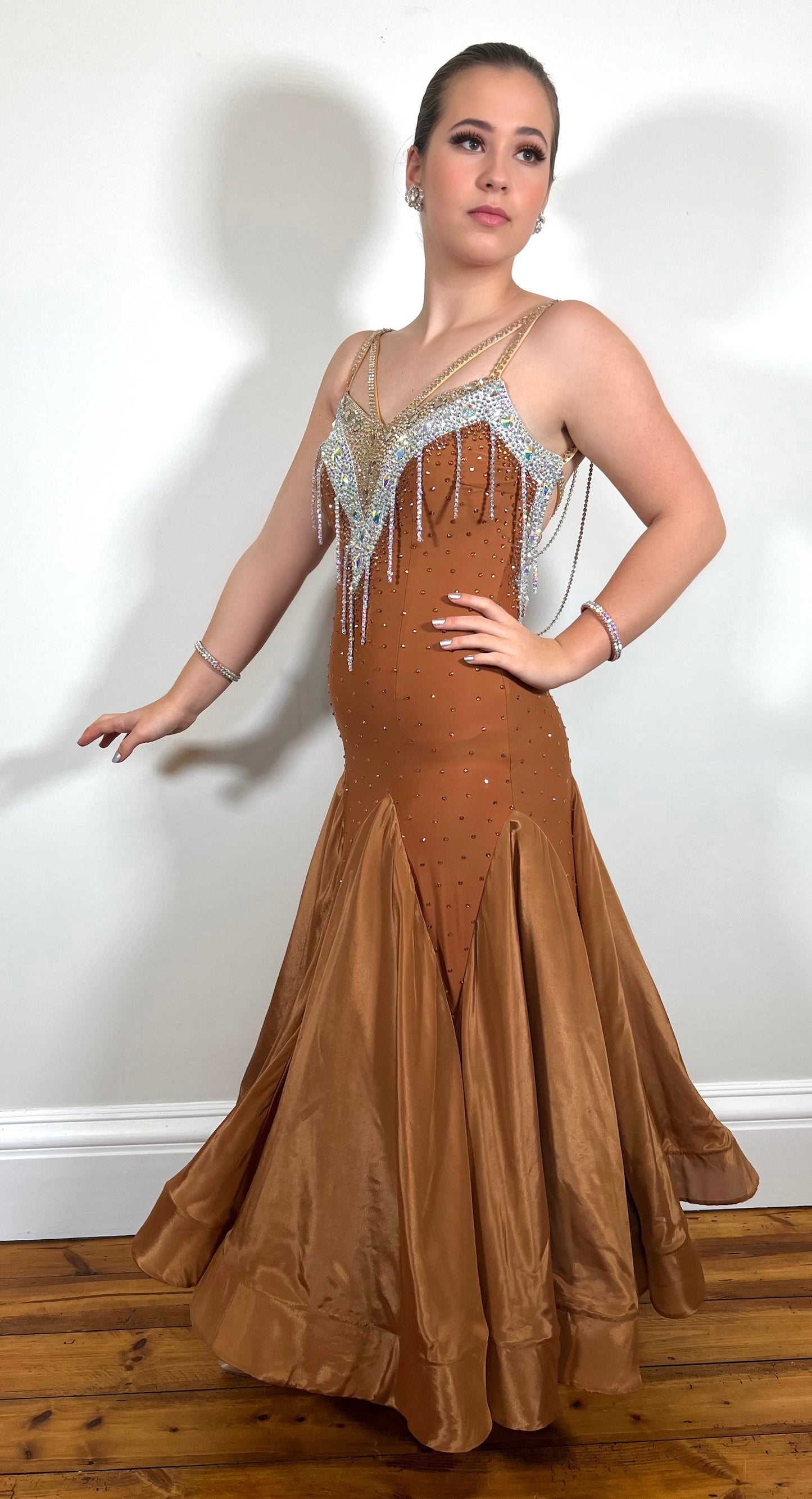 246 Cappuccino Ballroom Dress. Comes with Gloves & detachable glove floats. Stoned in Aurum, Sunshine, Smoked Topaz & Topaz. Strap feature to the back & shoulders