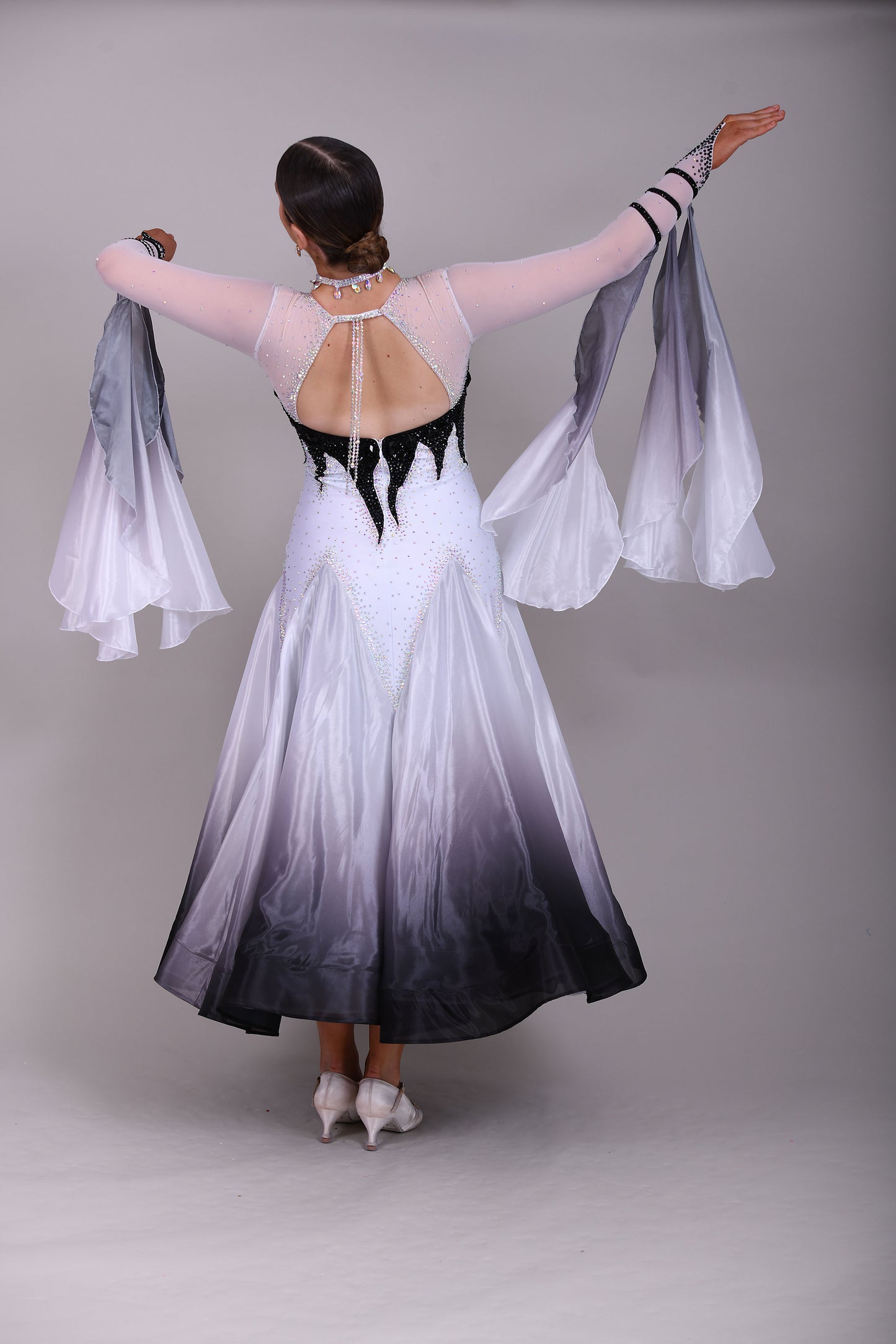 01140 Black & White Ombre Competition Ballroom Dance Dress Upper chest heavily stoned Jet. Pearl Chiffon Ombre skirts. The upper chest is white mesh with skin fabric underneath, giving the illusion of skin. Detachable Floats.