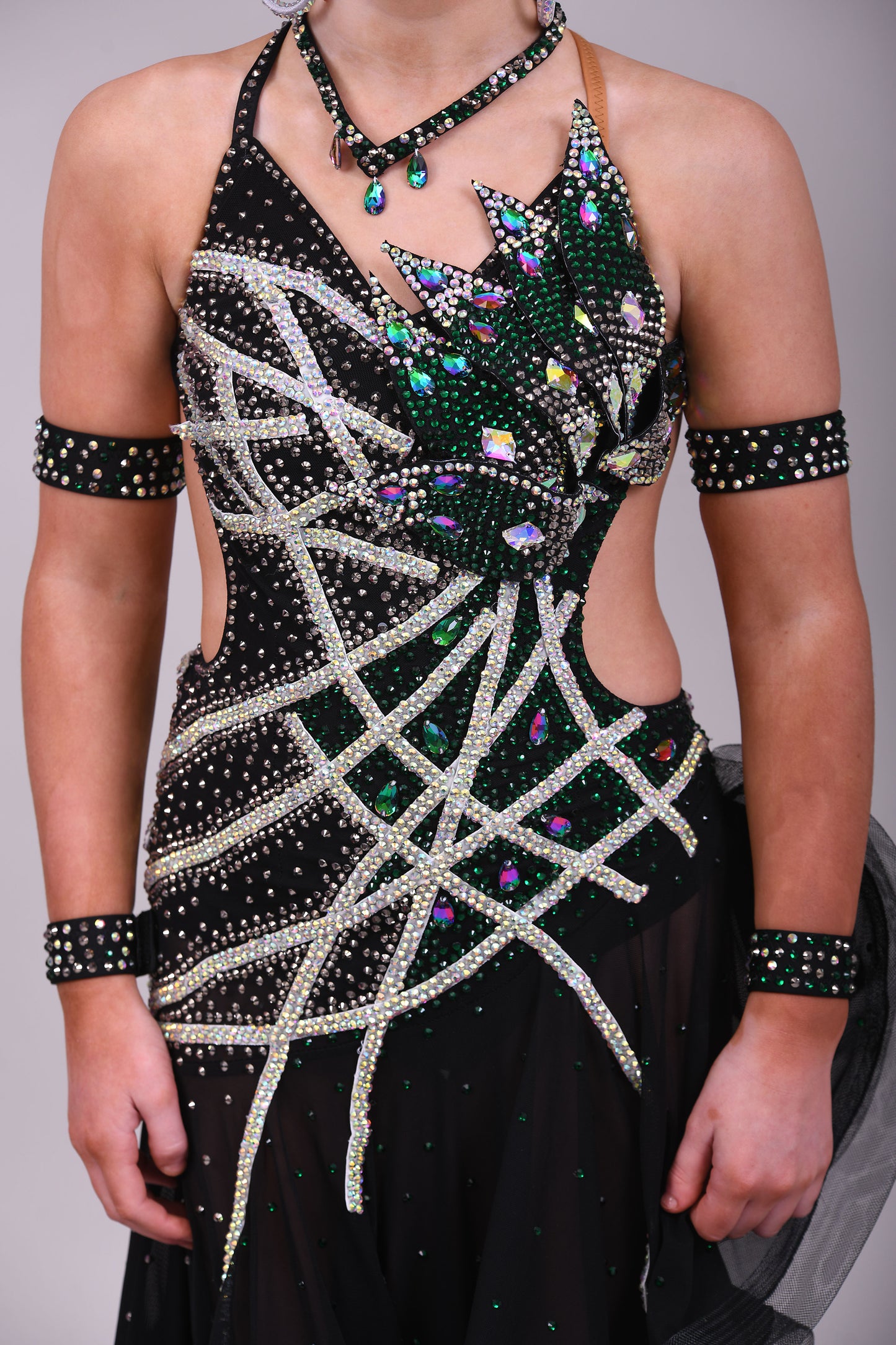097 Black Heavily Stoned Gem Latin Dress. 3D design to the chest. Backless dress with crinoline edged skirt. Stoned in AB