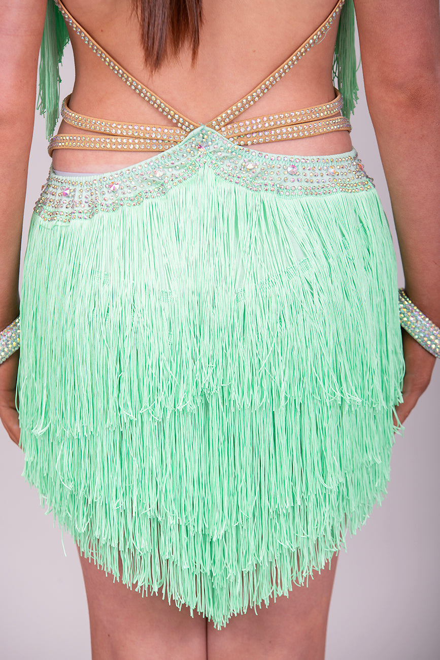 (BUDGET)2 Green Latin Competition Dance Dress. Full Fringed Skirts with shoulder & waist detailing. 2 Bangles included.                                     *****Our New Budget Range are Bought in ready made Costumes, with some detail added by TWDance*****