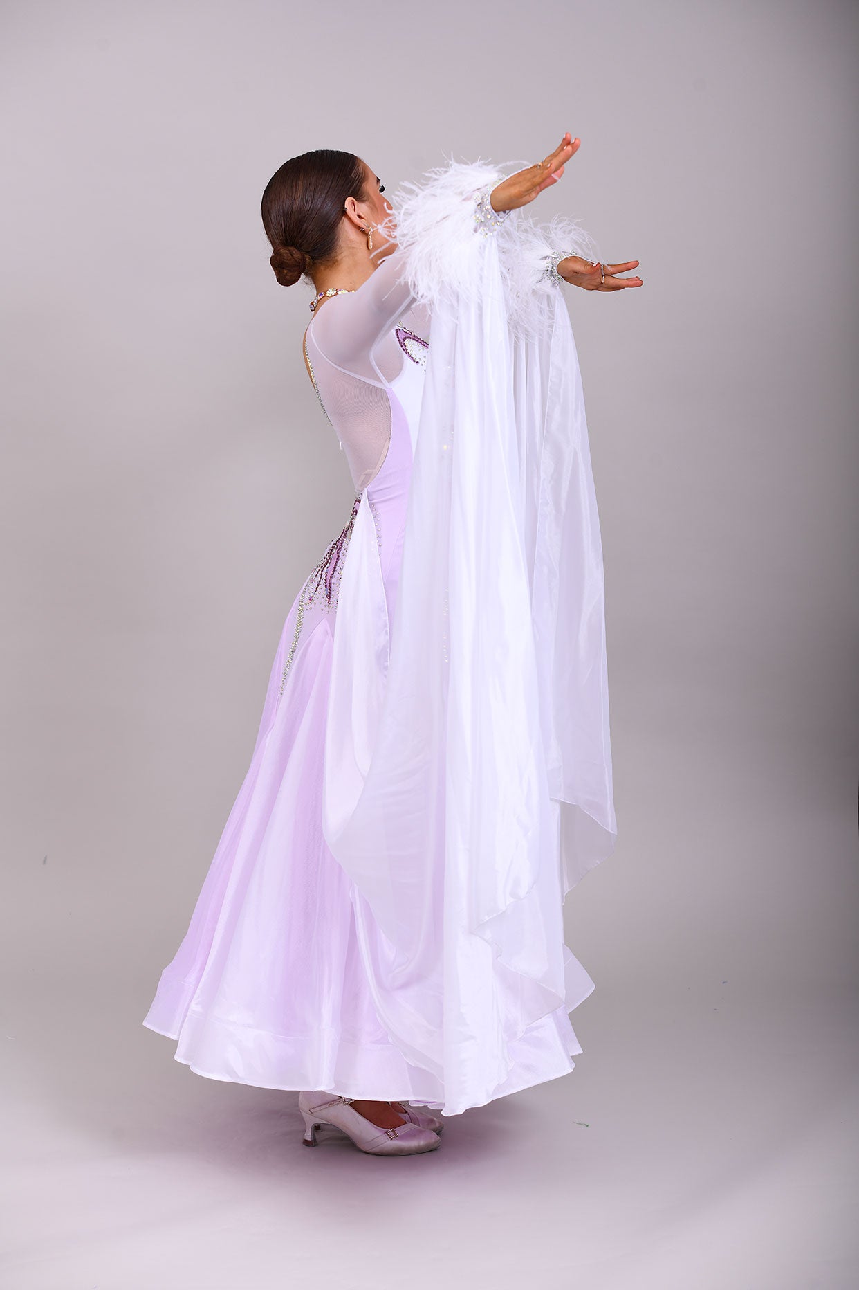 233 White Dress with lilac underlayer to the skirt. White floats. Decorated in lilac & AB stones with ostrich feather detail to the cuffs