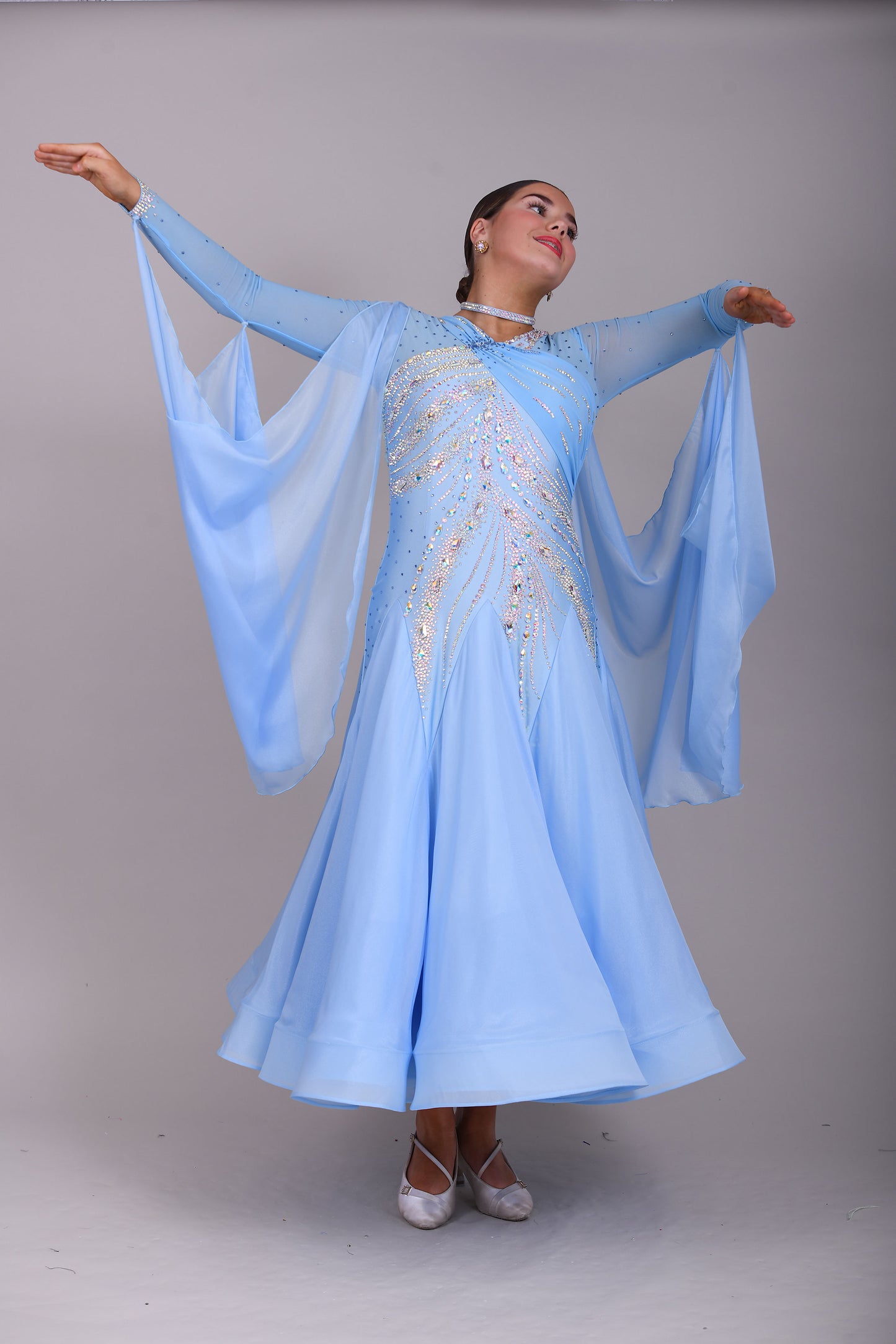 007 Light Blue Competition Ballroom Dance Dress. Heavily stoned in AB & Blue. Mesh overlay to one side of the bust continuing round to the back. Comes with detachable floats.
