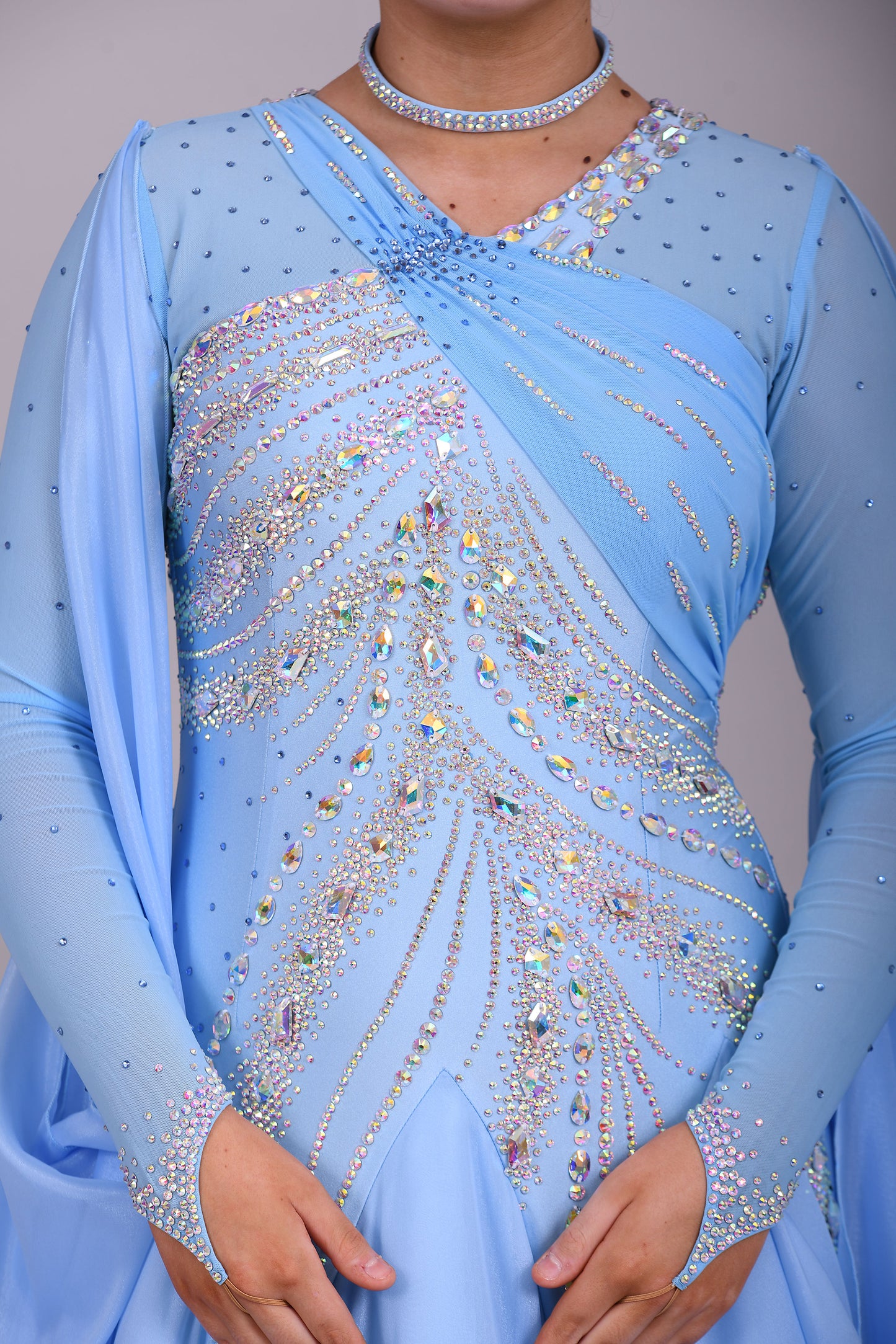 007 Light Blue Competition Ballroom Dance Dress. Heavily stoned in AB & Blue. Mesh overlay to one side of the bust continuing round to the back. Comes with detachable floats.