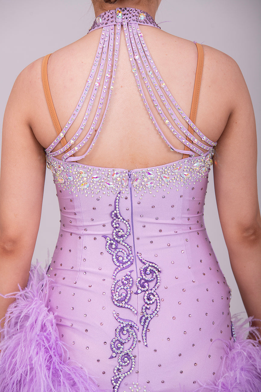 344 Lilac Latin Dress with keyhole halter neck detail. Strapping design on back. Lilac ostrich feather boa skirt. Decorated with purple motif. Stoned in green & AB Boa is hand stitched so could be rearranged