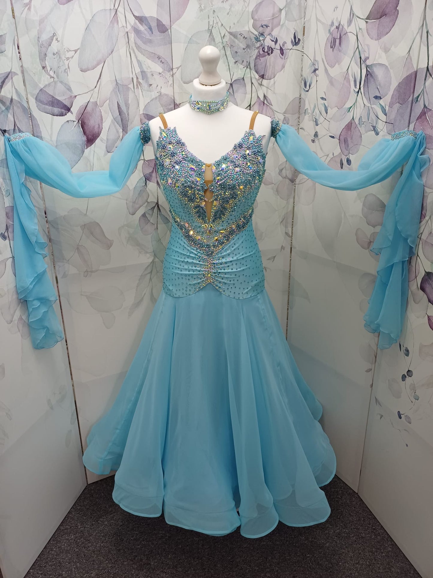 72B TWD Petite Beautiful Blue Competition Ballroom/Sequence Dance Dress. Heavy appliqué stoning to upper chest in Light Sapphire & AB. Separate puff arms with detachable wrist floats. ❤️Showroom Appointments Available❤️