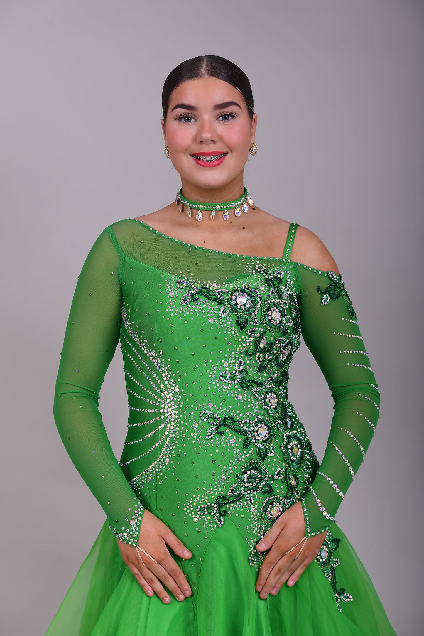 010 Apple Green one Shoulder, one cold shoulder Ballroom Dress. Appliqué stoned in AB & Jade to one side of the bodice.