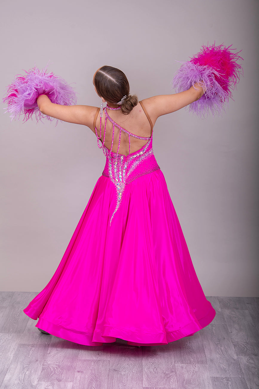 005 Cerise Pink Competition Ballroom Dance Dress. Heavily stoned in AB and Fuchsia & lilac. Comes with ostrich cuffs in Lilac & Cerise. Beautiful back detail.