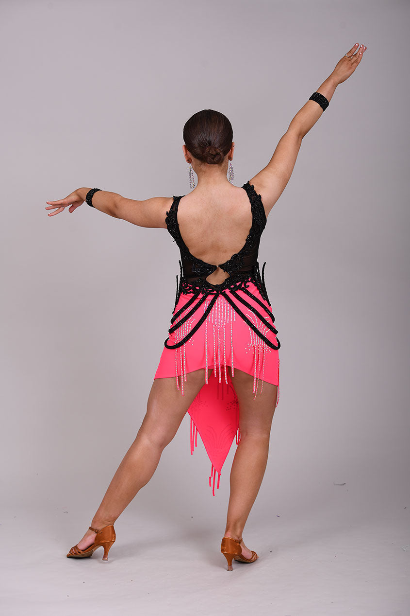 084 Black & Electric Pink Latin Dress. Black mesh bodice decorated with black appliqué & jet stones. Stoned material hip straps. Skirt decorated in AB