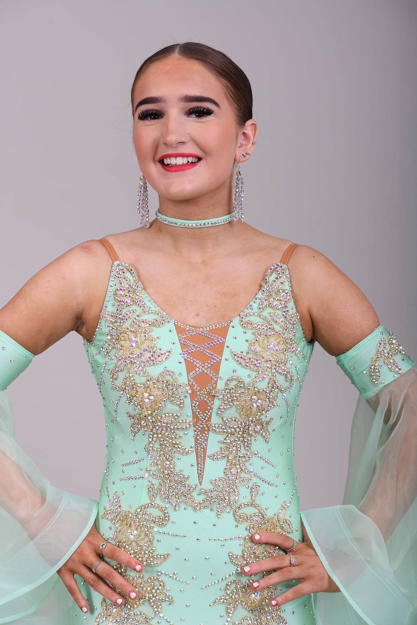 327 mint Green & Gold Ballroom Dress. Decorated with Gold motifs & AB Stones. Comes with separate floaty sleeve cuffs.