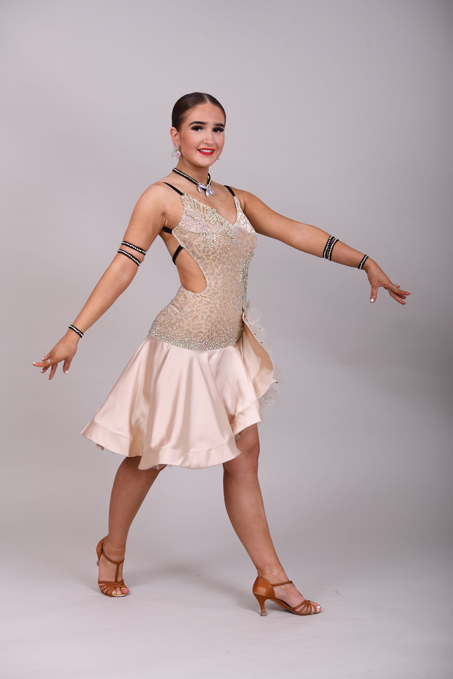 175 Champagne flesh Leopard fabric Latin dress. Soft satin skirt with motif detailing to one hip. Gold appliqué with AB stones