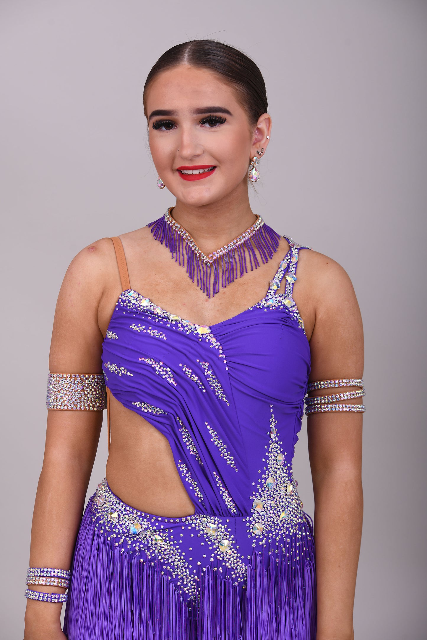 173 Cadbury Purple Latin dance dress. Rouched detailing to the upper body, full fringed skirt. Stoned in AB