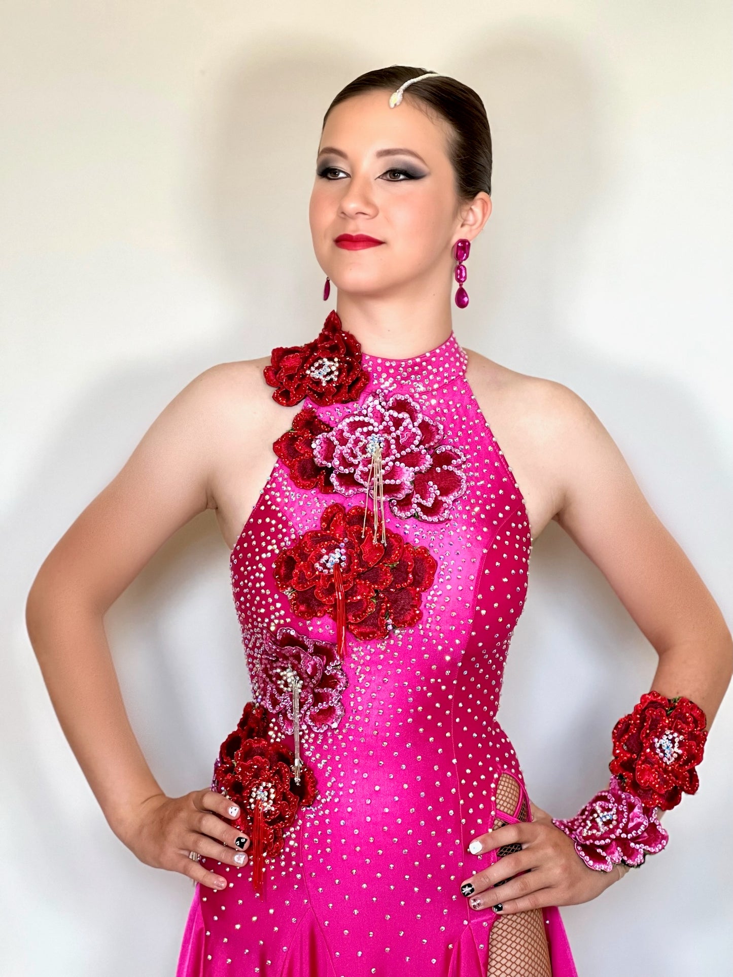 018 Magenta Halter neck style Latin dress. Shaped skirt with side split. 3D flower decorations to the front & back of bodice. Flowers to wrist cuff.