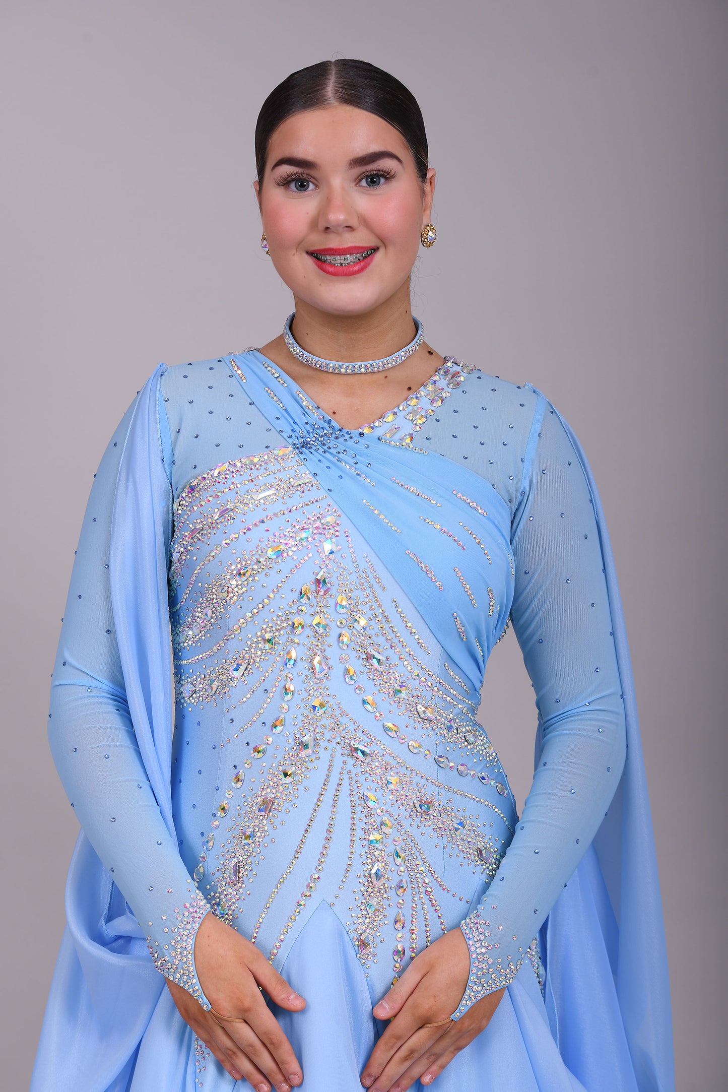 007 Light Blue Competition Ballroom Dance Dress. Heavily stoned in AB & Blue. Mesh overlay to one side of the bust continuing round to the back. Comes with detachable floats.