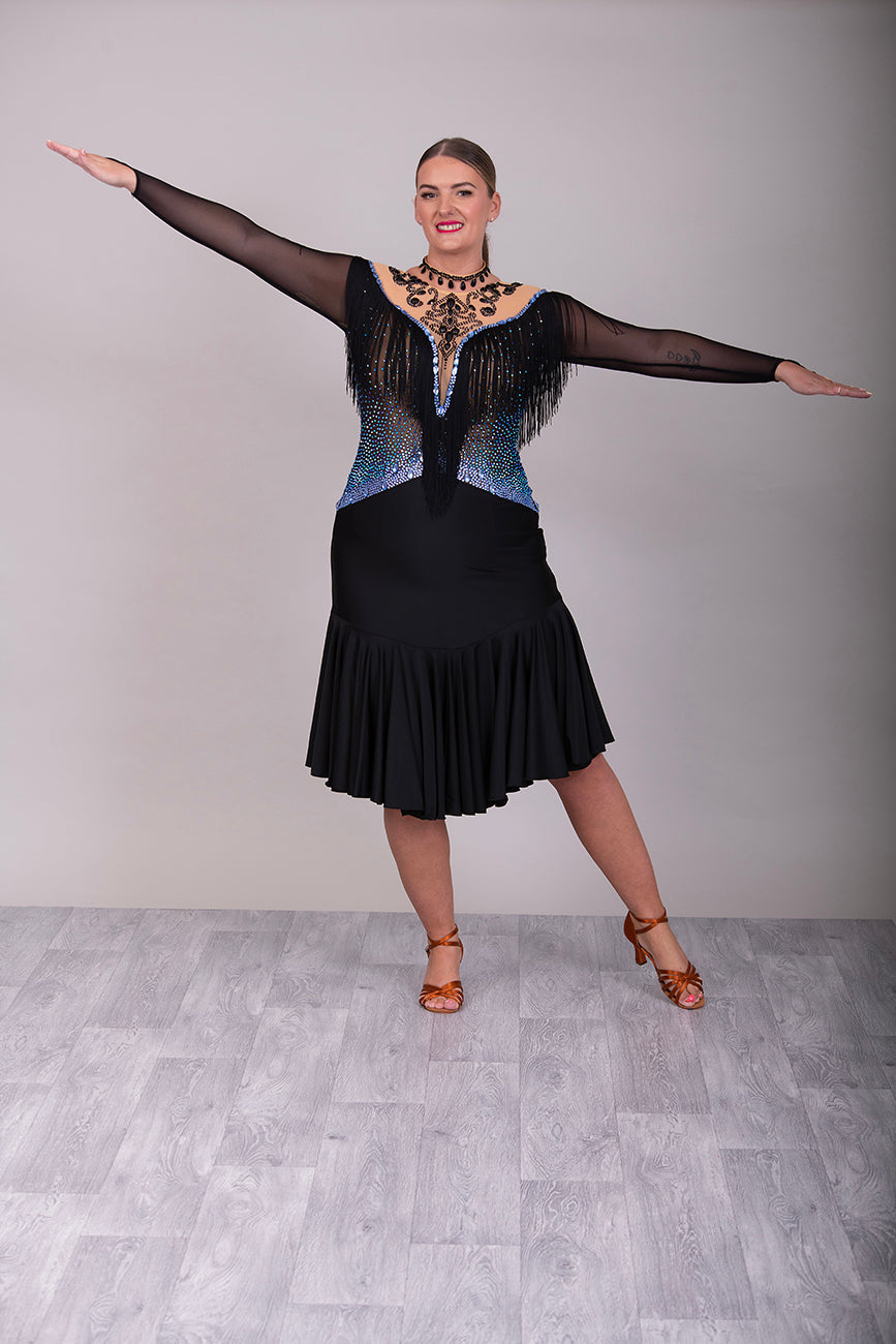 279 Black Competition Latin Dress. Stoned in Sapphire AB & Jet stones. Off the shoulder effect mesh. Black fringe detail to front & back. Full frill skirt giving lovely movement.