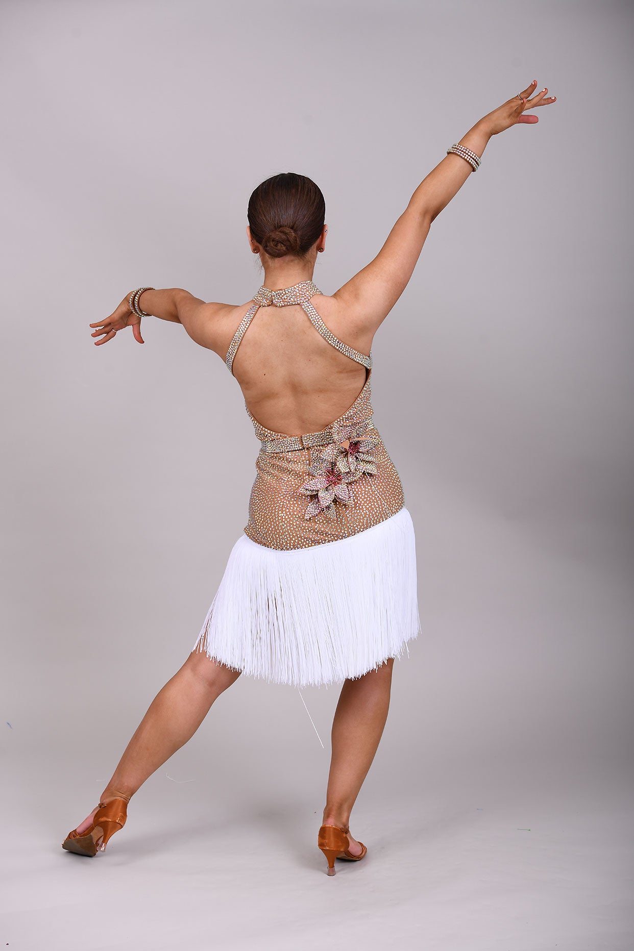 299 Tan & white Latin Dress. 3D flower detailing with white fringe skirt. AB & Rose stoning with separate belt.