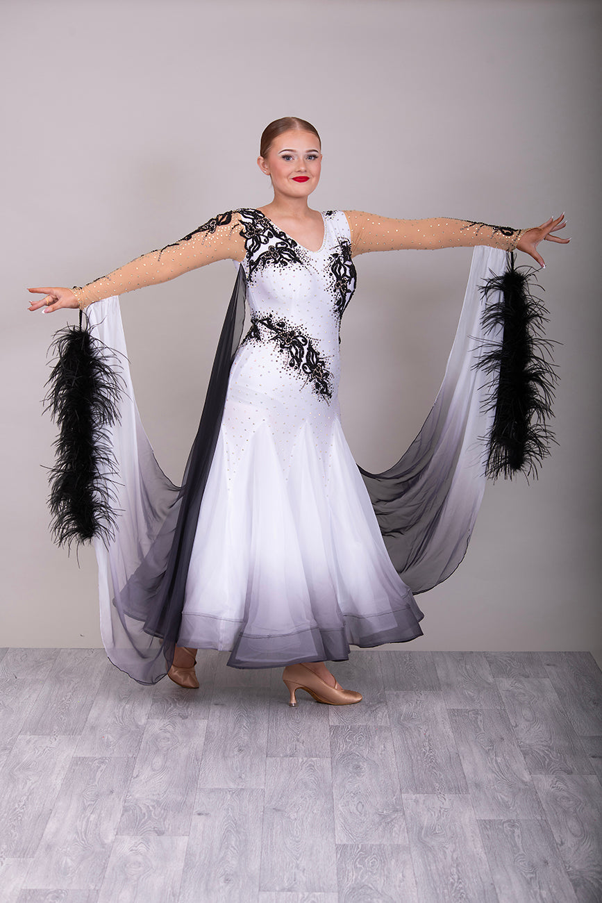 048 White Ballroom Dress with Black lace detailing to the upper chest & sides. Comes with x2 cuffs decorated with appliqué. Stoned in AB and Jet