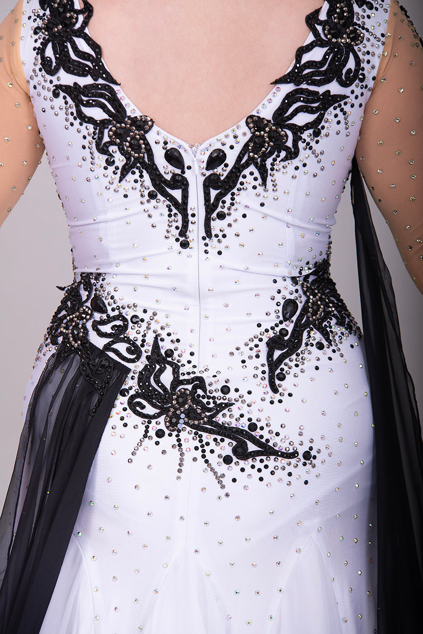 048 White Ballroom Dress with Black lace detailing to the upper chest & sides. Comes with x2 cuffs decorated with appliqué. Stoned in AB and Jet