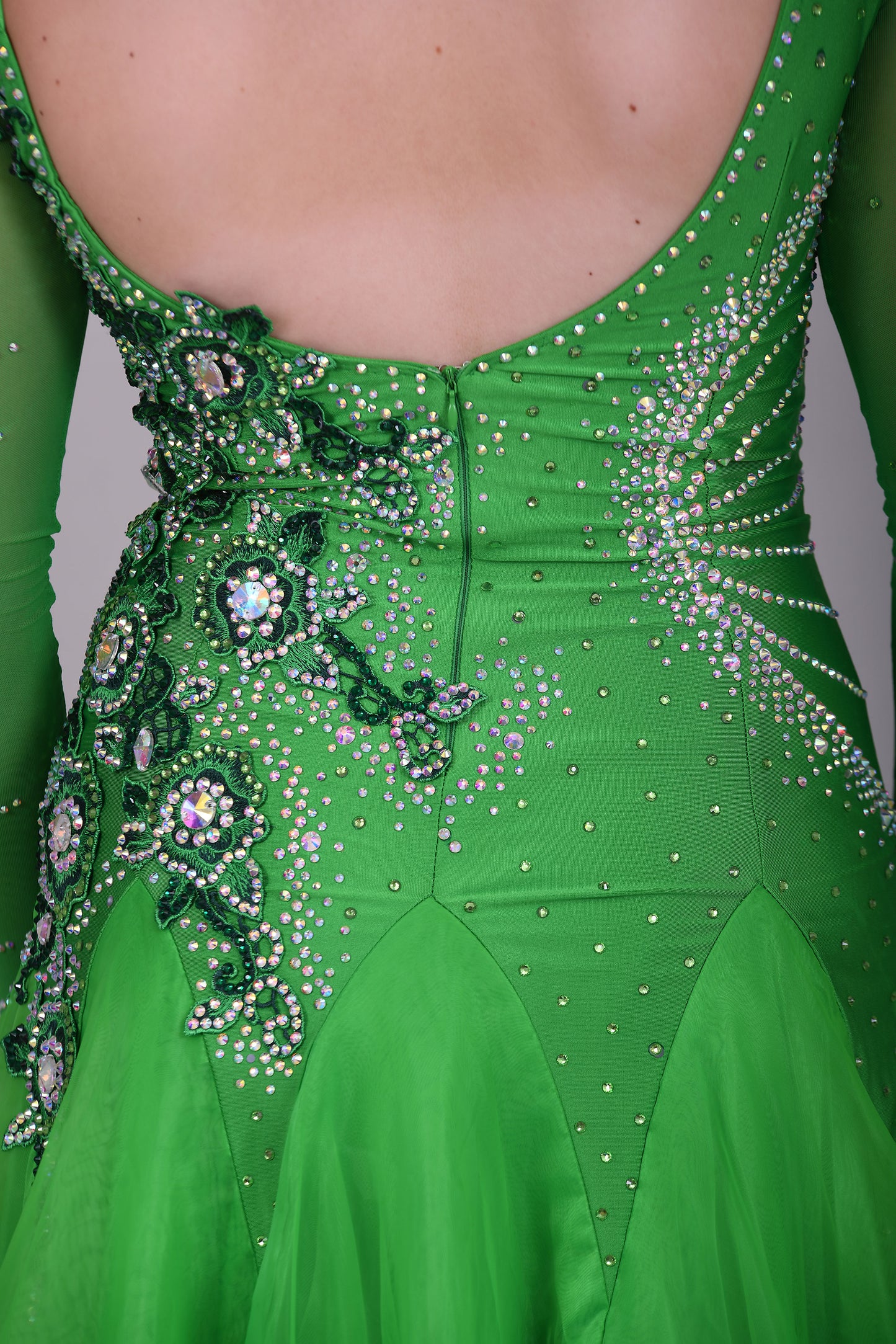 010 Apple Green one Shoulder, one cold shoulder Ballroom Dress. Appliqué stoned in AB & Jade to one side of the bodice.