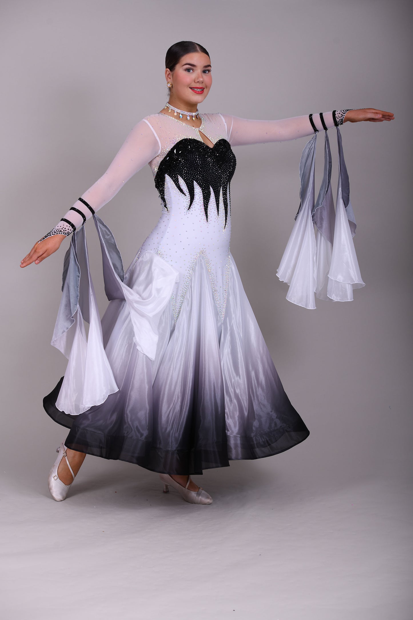 01140 Black & White Ombre Competition Ballroom Dance Dress Upper chest heavily stoned Jet. Pearl Chiffon Ombre skirts. The upper chest is white mesh with skin fabric underneath, giving the illusion of skin. Detachable Floats.