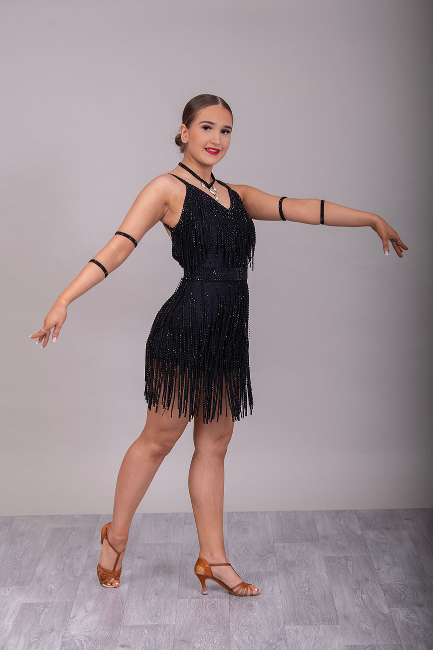 24L Black Latin/Rhythm Competition Dance Dress. Heavily stoned in Black with optional Belt. Stoned Fabric strips to the chest area and skirt. Cones with Necklace & Armbands