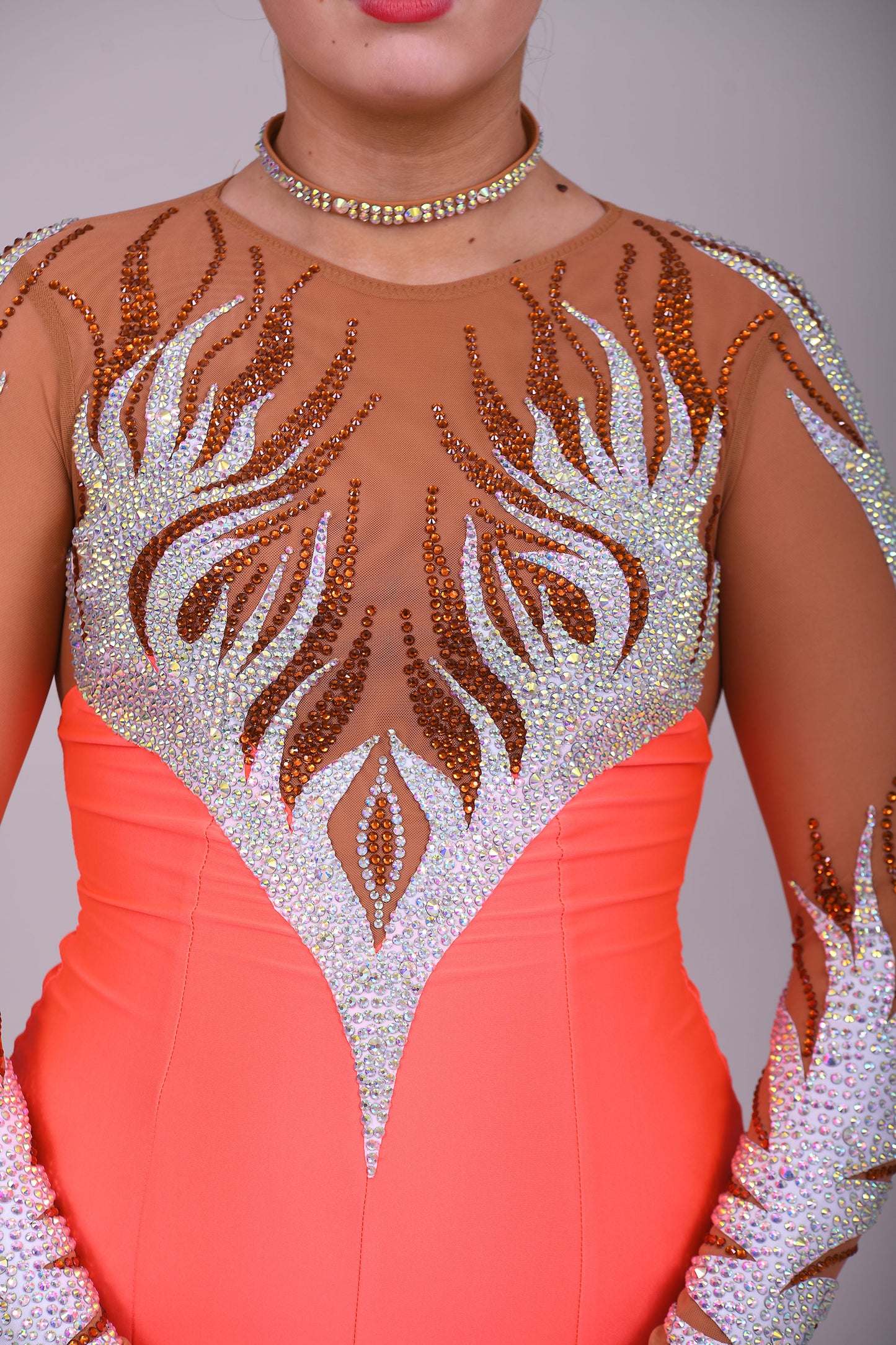 228 Orange & Tan Latin Dress. Heavy decoration design to the front & back. Small split to the left front side. High back with zip. Stoned in smoked topaz & AB