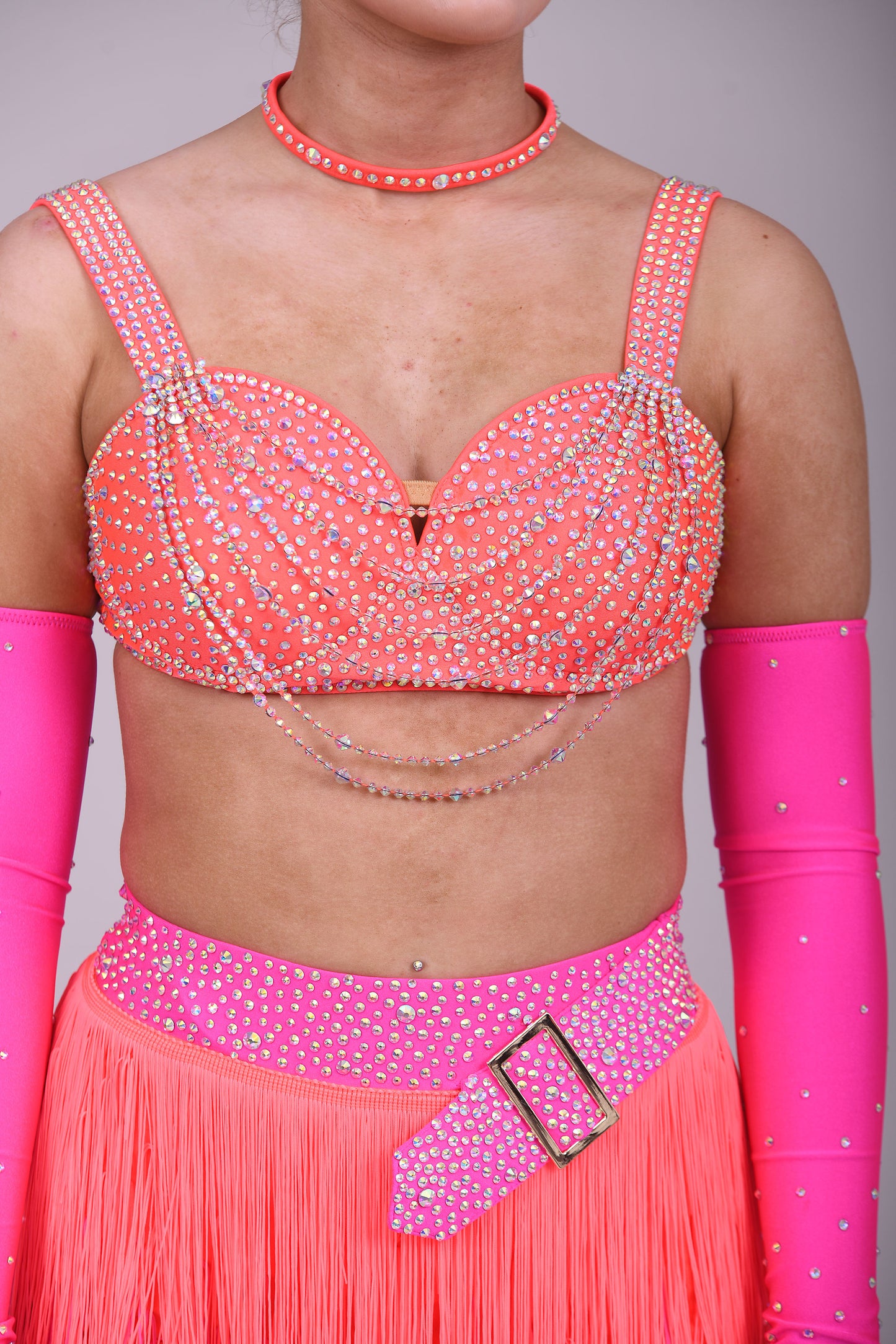 153 Flo Pink & Flo Orange Latin Dance Dress 2 Piece. Comes with separate gloves. Heavily stoned in AB with belt detail to the skirt