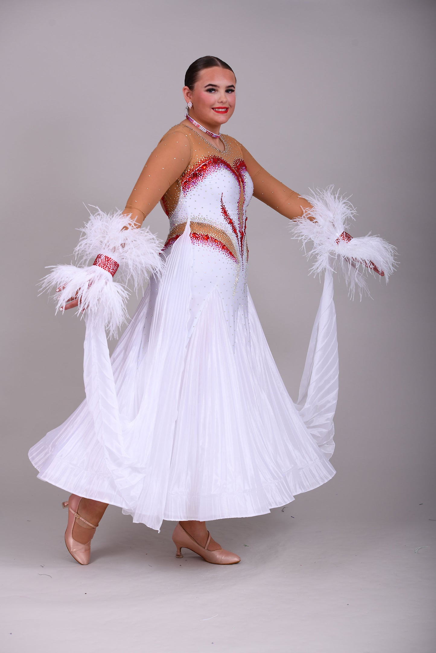 011 White & Mid Tan Competition Ballroom Dance Dress. Pleated pearl Chiffon skirt with beautiful keyhole Back. Stoned accents in Siam, Siam AB, AB & Golden Shadow. Comes with detachable pleated floats and feather cuffs.