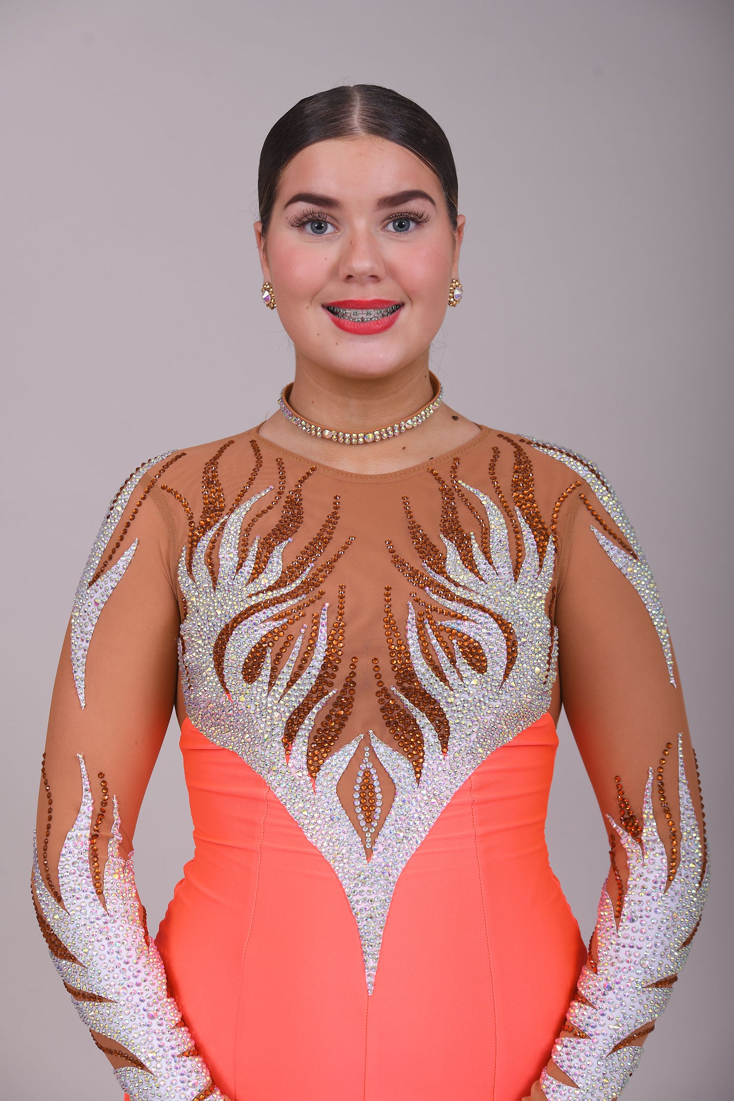 228 Orange & Tan Latin Dress. Heavy decoration design to the front & back. Small split to the left front side. High back with zip. Stoned in smoked topaz & AB