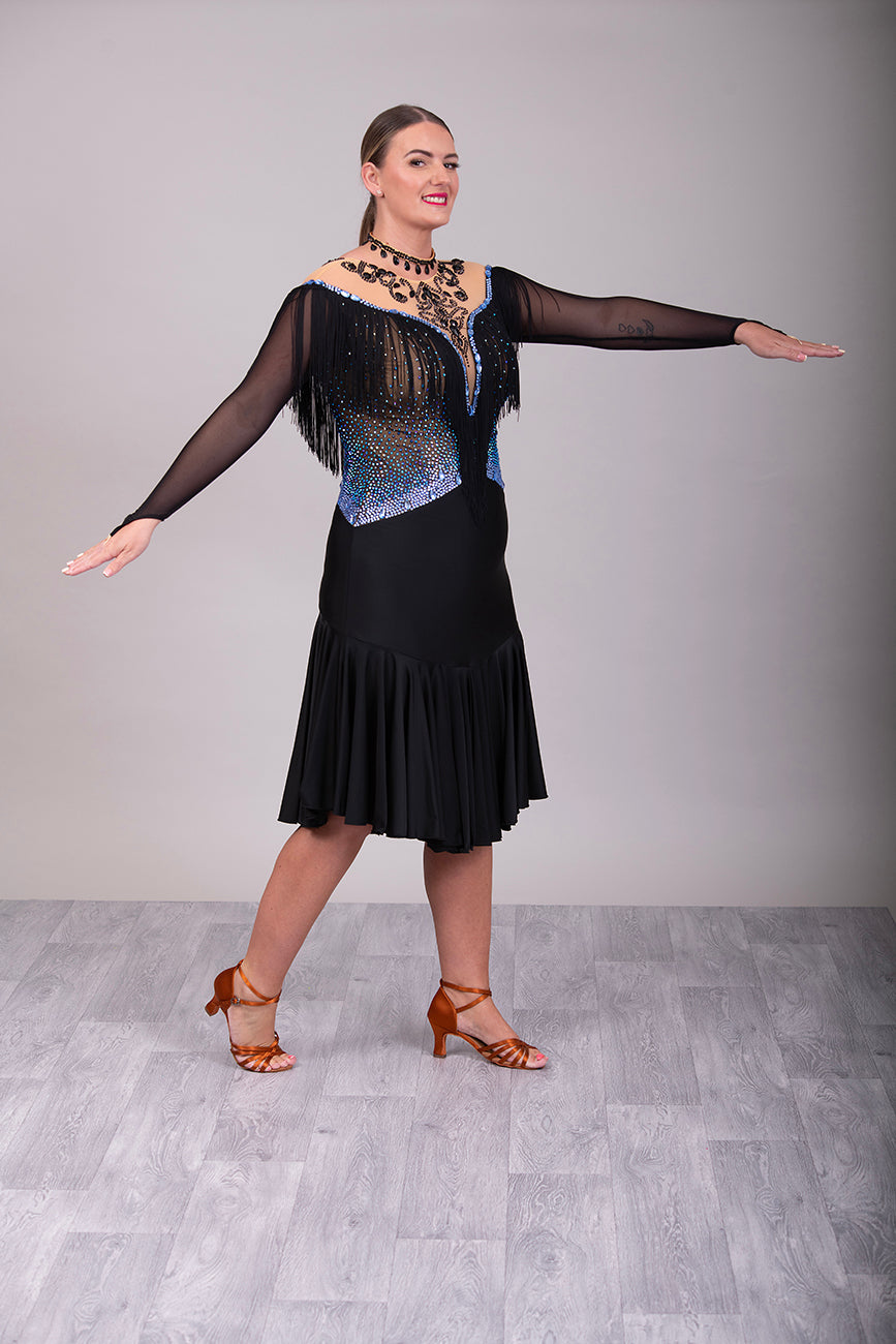 279 Black Competition Latin Dress. Stoned in Sapphire AB & Jet stones. Off the shoulder effect mesh. Black fringe detail to front & back. Full frill skirt giving lovely movement.