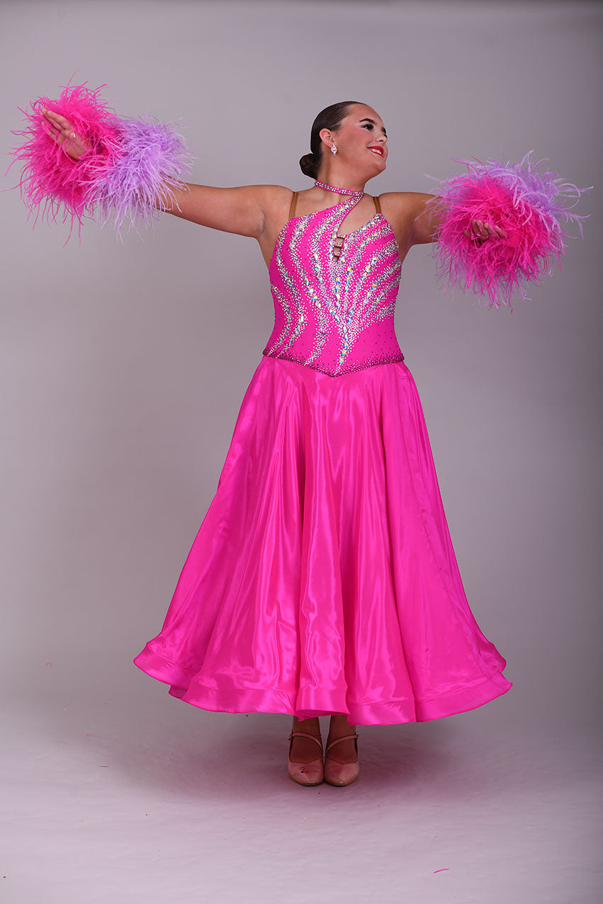 005 Cerise Pink Competition Ballroom Dance Dress. Heavily stoned in AB and Fuchsia & lilac. Comes with ostrich cuffs in Lilac & Cerise. Beautiful back detail.