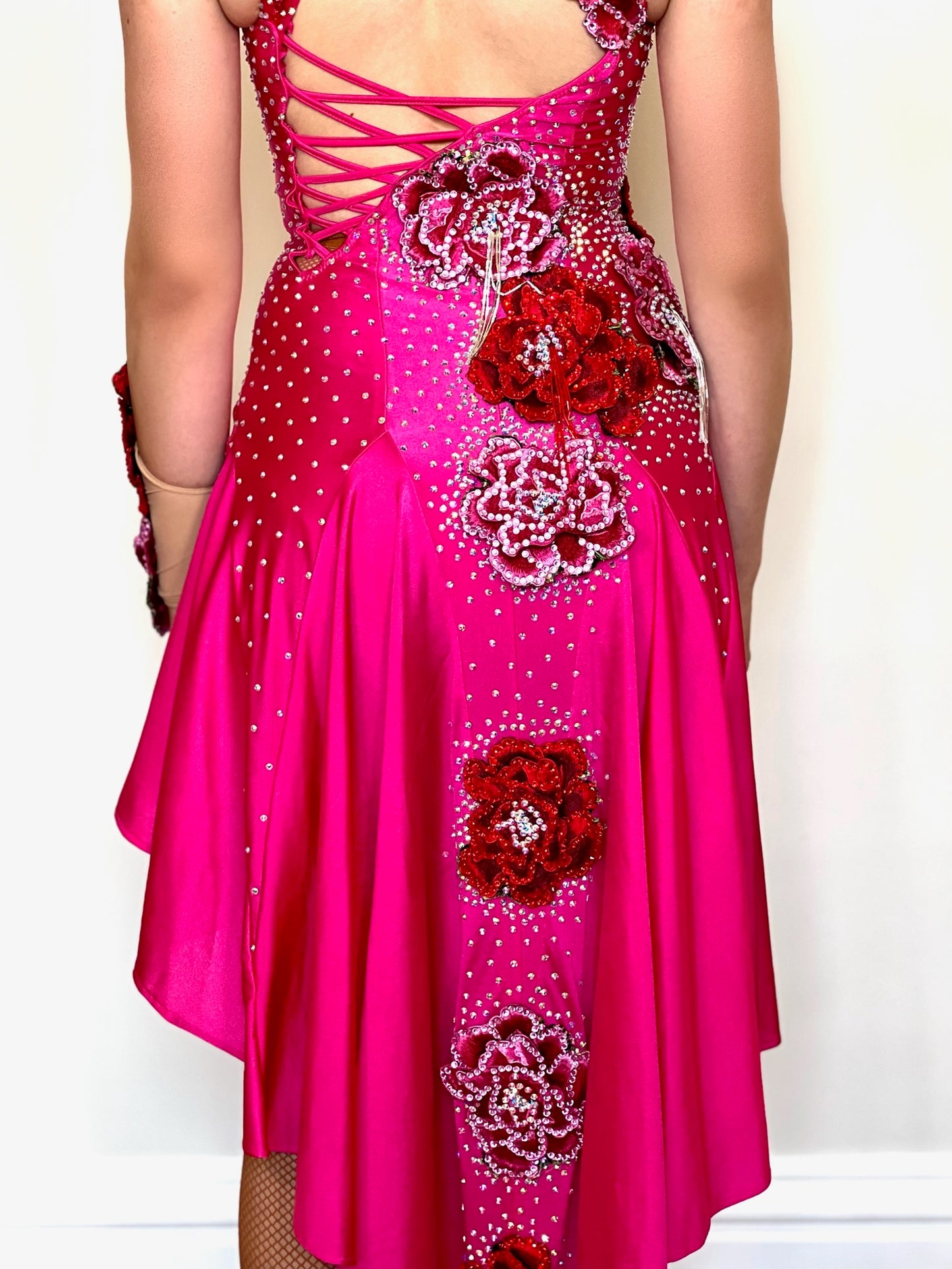018 Magenta Halter neck style Latin dress. Shaped skirt with side split. 3D flower decorations to the front & back of bodice. Flowers to wrist cuff.