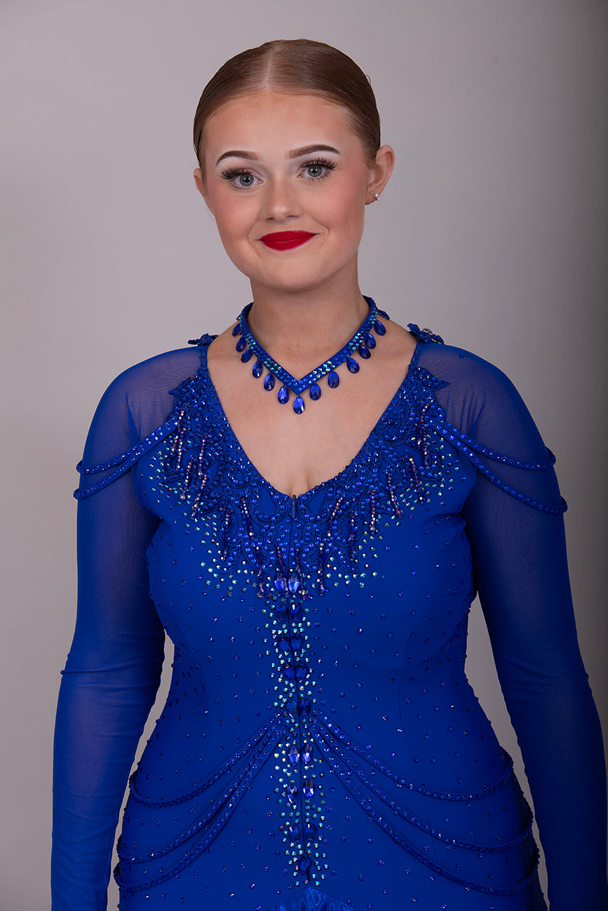 339 Bright Royal Blue Ballroom Dress. Stunning detailing to the back with Strappy detail to the hips. Organza edged in ribbon. All stoned in Bright Royal Blue. Very comfortable Front Zip fastening.