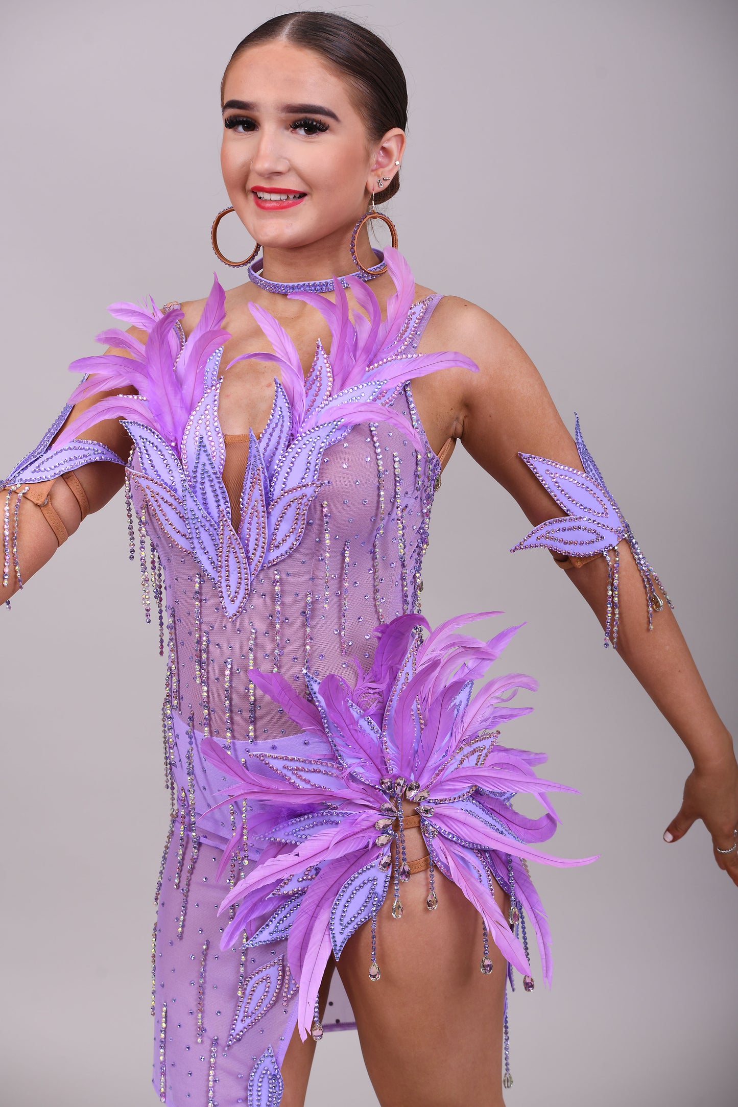 160 Lilac Latin dance dress. Stunning feather detailing to the upper chest & hip. Mesh fabric dress.
