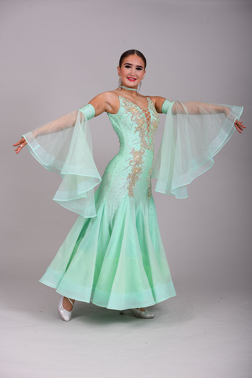 327 mint Green & Gold Ballroom Dress. Decorated with Gold motifs & AB Stones. Comes with separate floaty sleeve cuffs.