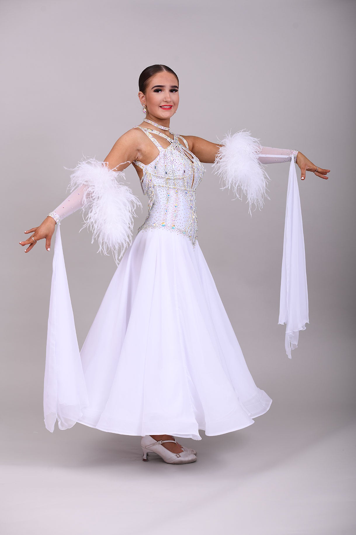 013 White Competition Ballroom/Sequence Dance Dress. Striking detailing to both the front & Back. Stoned in AB and sunshine. Cones with gloves, floats & Ostrich Boa cuffs.
