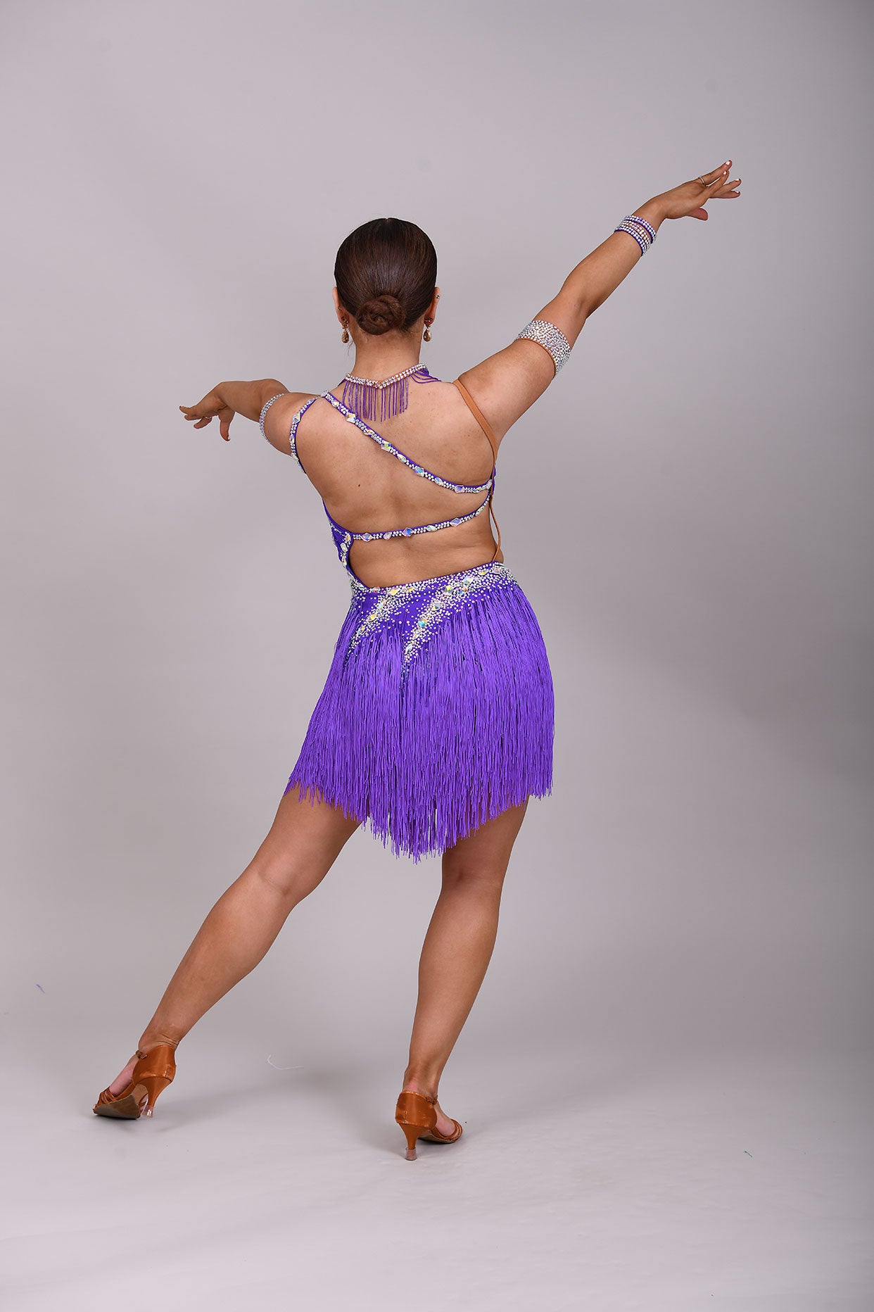 173 Cadbury Purple Latin dance dress. Rouched detailing to the upper body, full fringed skirt. Stoned in AB
