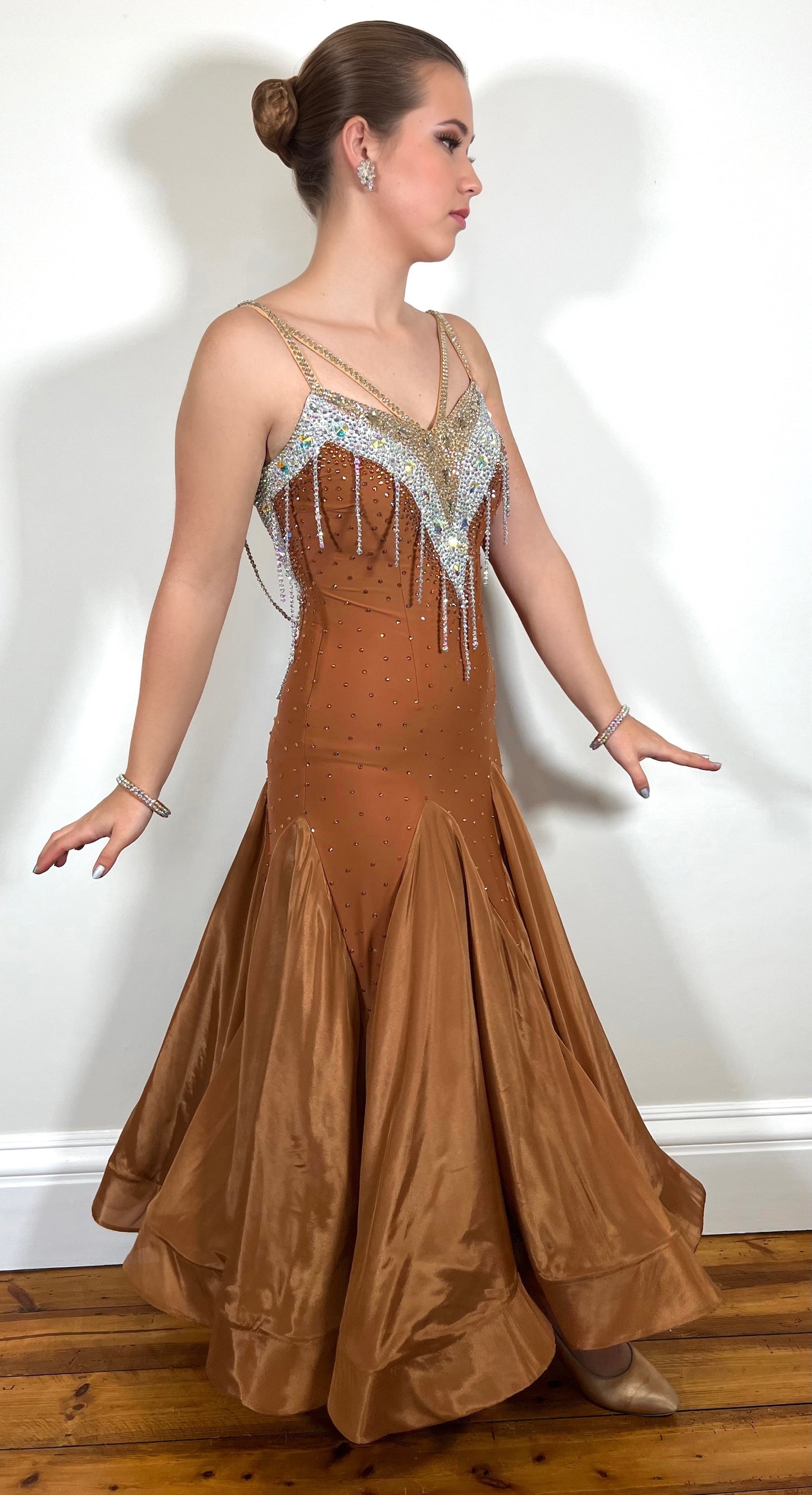 246 Cappuccino Ballroom Dress. Comes with Gloves & detachable glove floats. Stoned in Aurum, Sunshine, Smoked Topaz & Topaz. Strap feature to the back & shoulders