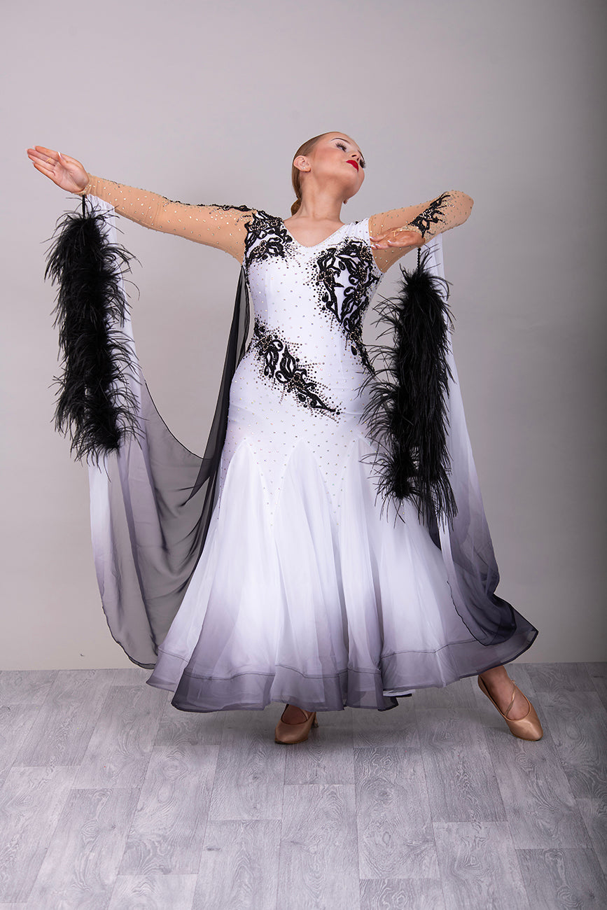 048 White Ballroom Dress with Black lace detailing to the upper chest & sides. Comes with x2 cuffs decorated with appliqué. Stoned in AB and Jet