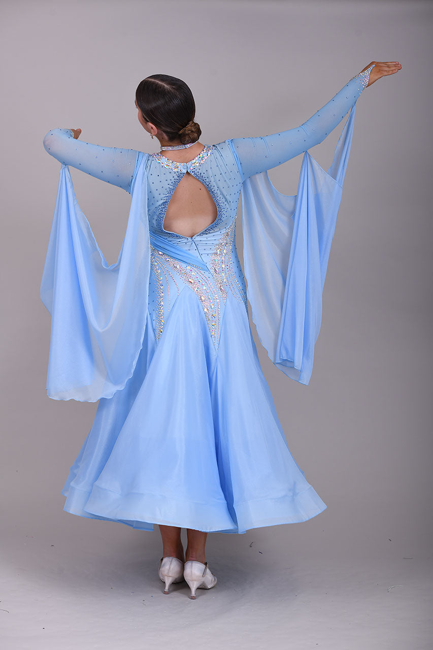 007 Light Blue Competition Ballroom Dance Dress. Heavily stoned in AB & Blue. Mesh overlay to one side of the bust continuing round to the back. Comes with detachable floats.