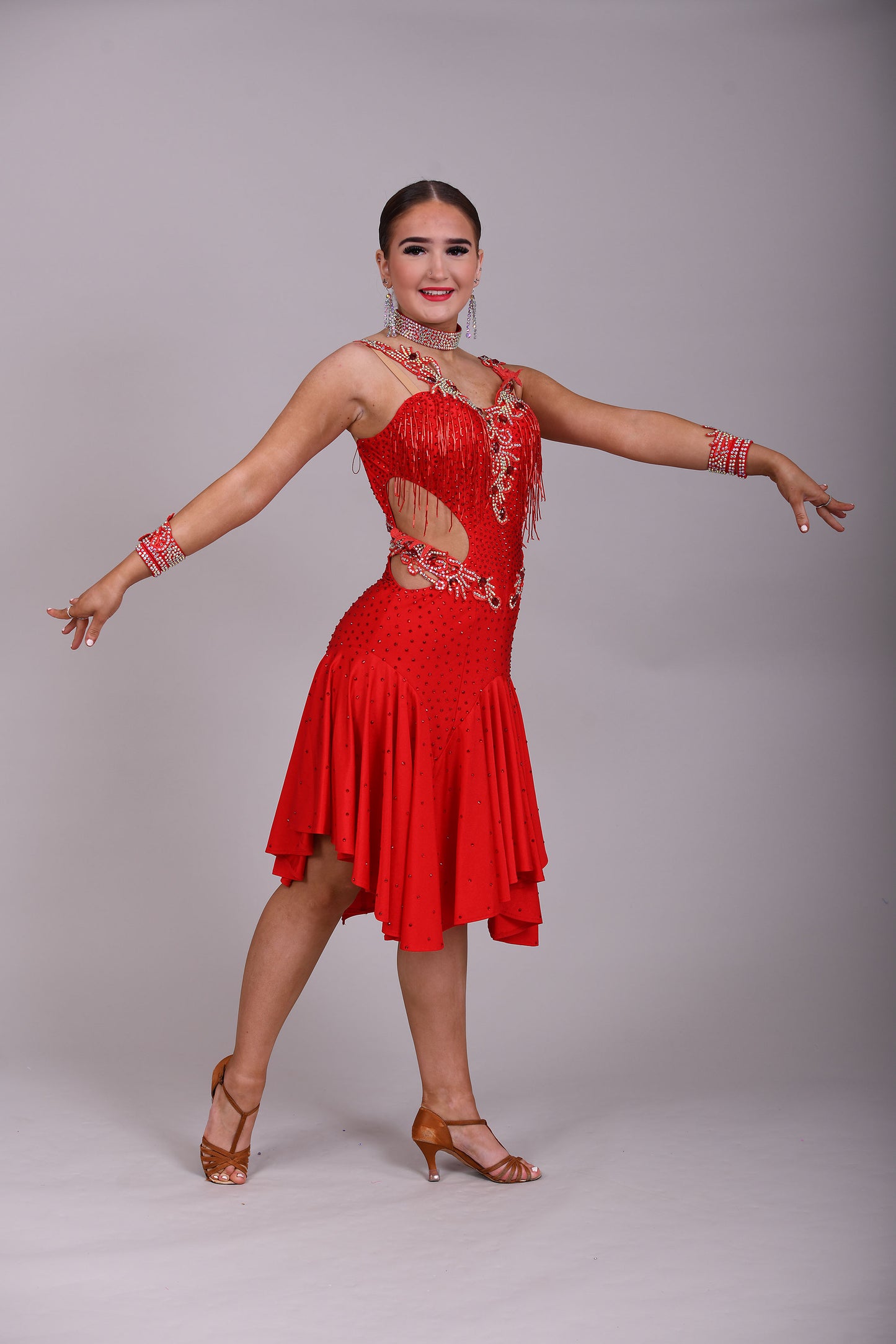 206 Red Lycra Dress with super full skirts. Motif detailing to back. Decorated with Siam bead droppers, cut out sides decorated in Siam & AB stones