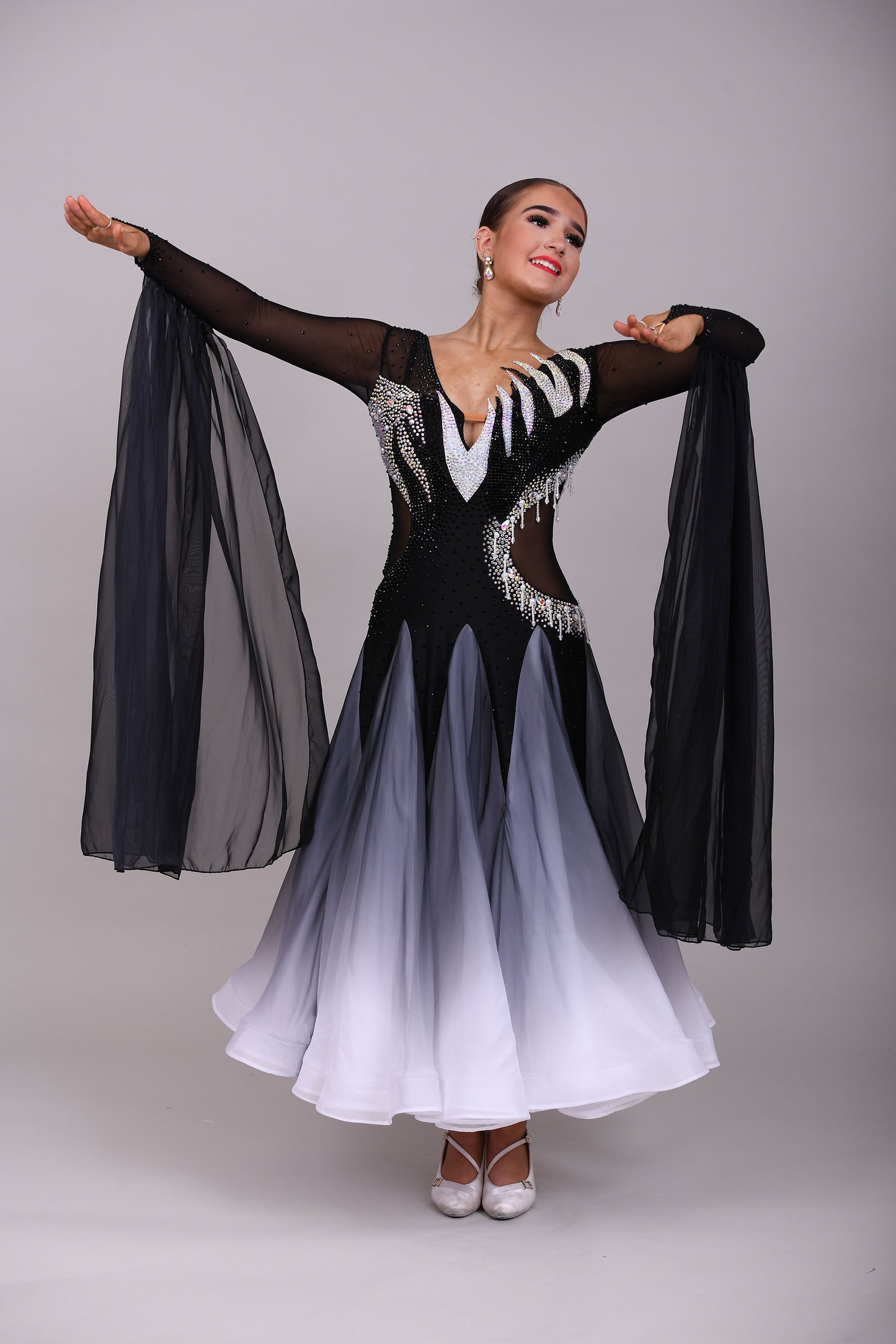 331 White & Black Ombré Ballroom Dress. Detailing to the chest and back. Decorated in Jet and AB stones with floats from the lower arm.