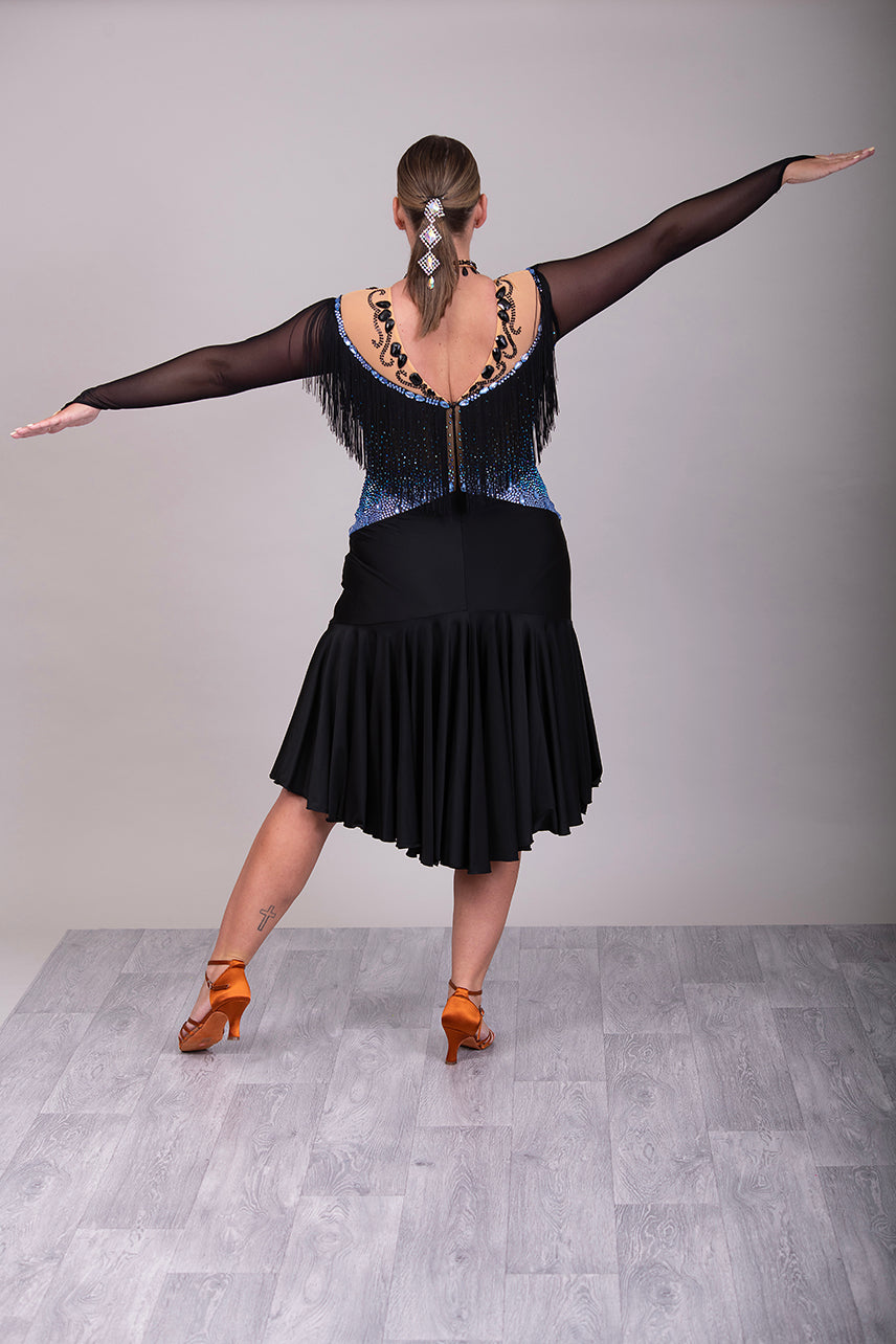 279 Black Competition Latin Dress. Stoned in Sapphire AB & Jet stones. Off the shoulder effect mesh. Black fringe detail to front & back. Full frill skirt giving lovely movement.