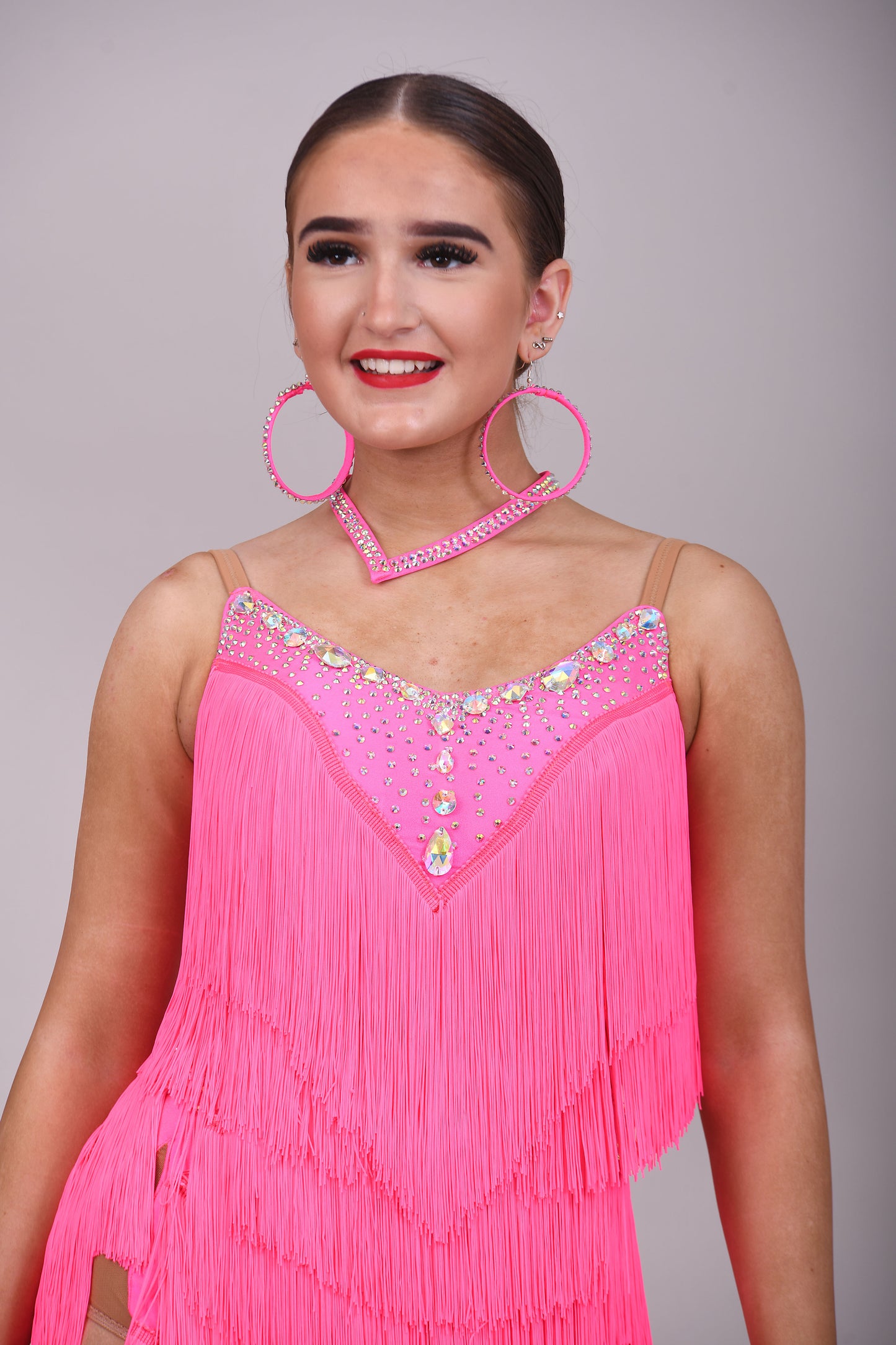 303 Flo Pink Latin Dress. Full fringed skirt decorated in AB Stones & open back detail