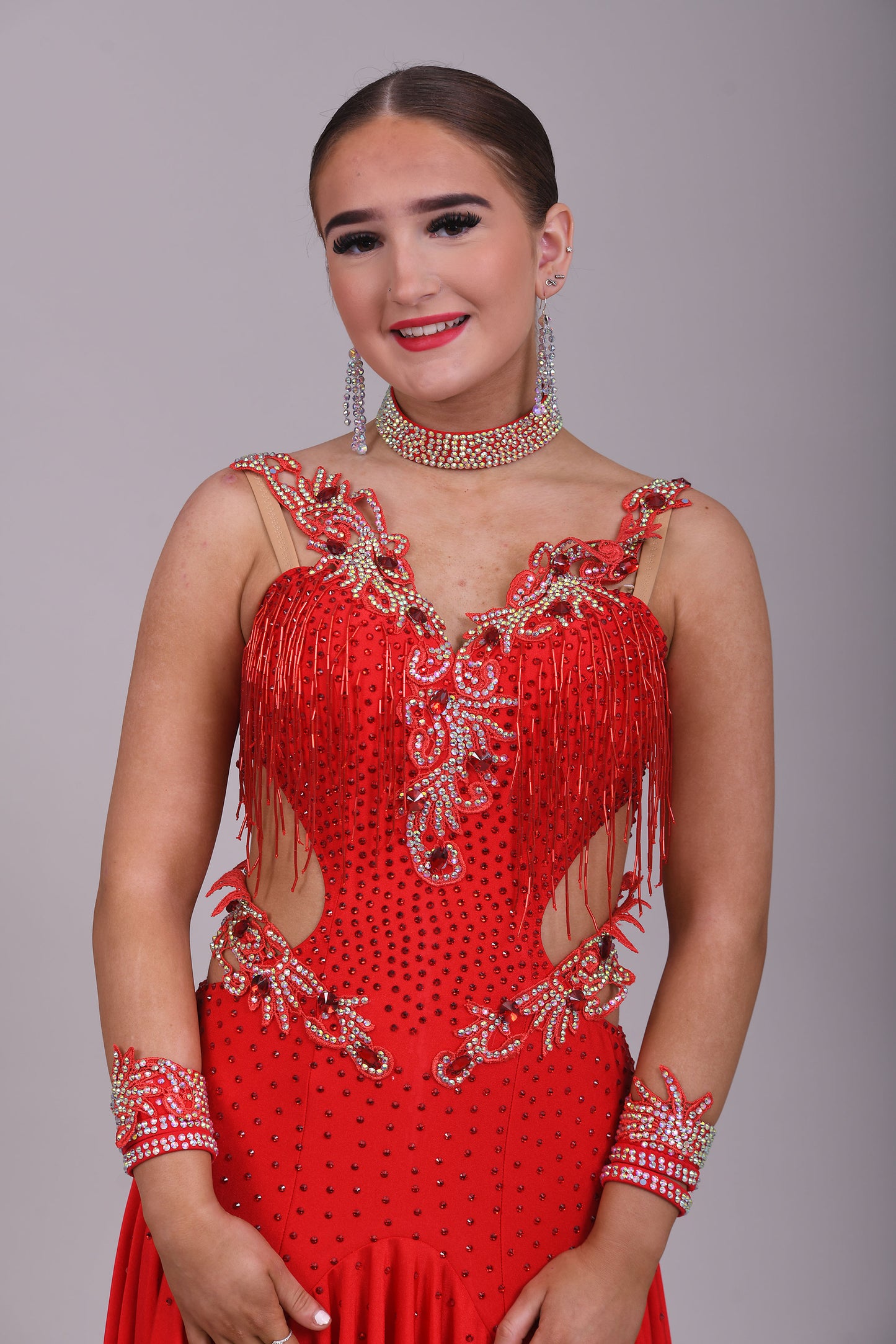 206 Red Lycra Dress with super full skirts. Motif detailing to back. Decorated with Siam bead droppers, cut out sides decorated in Siam & AB stones