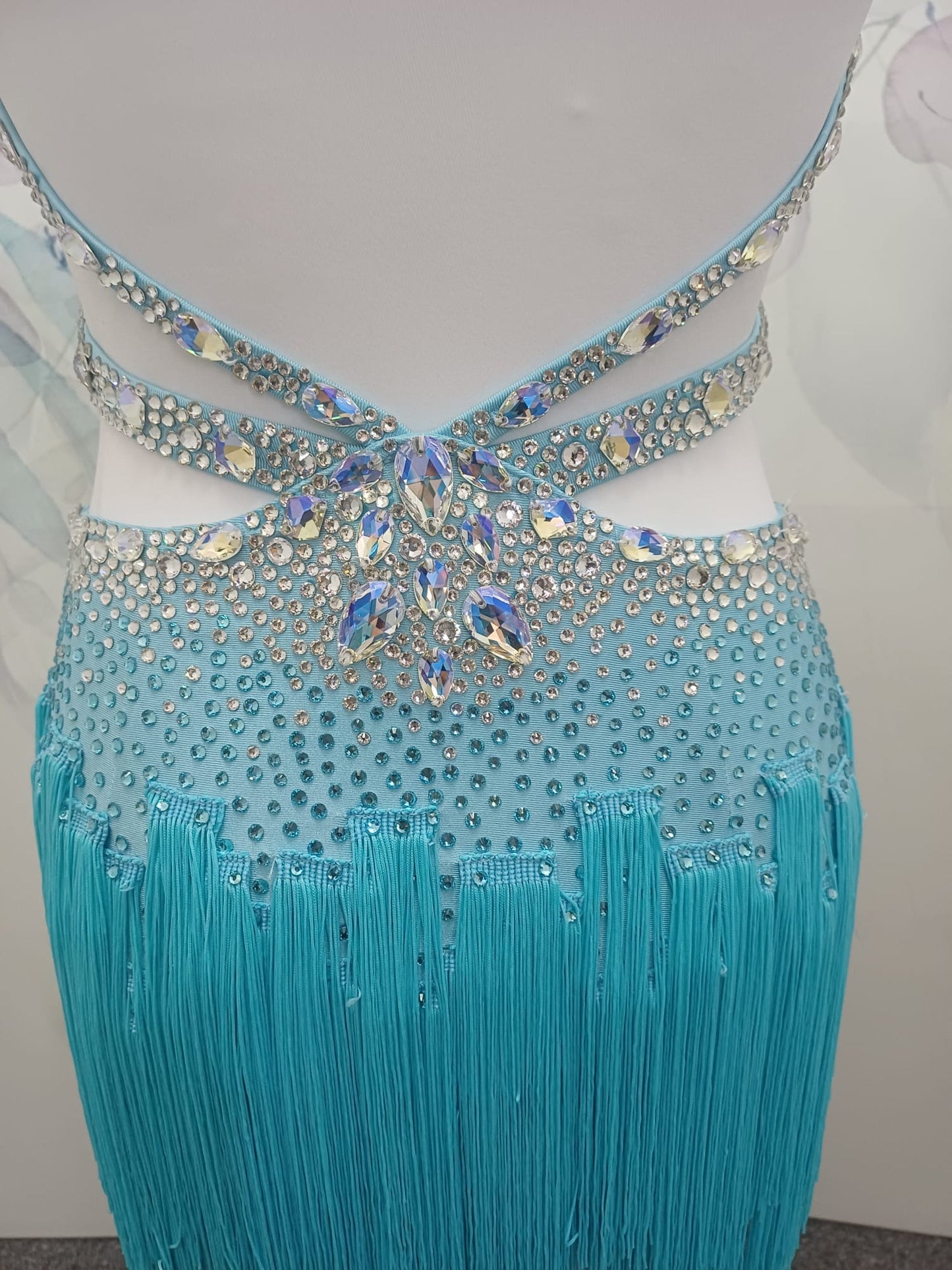 47L Paradise Blue Competition Latin Dance Dress. Beautiful detailing throughout with open design & strap details to the front. Comes with 8 bangles & matching Earrings. ❤️Showroom Appointments Available❤️